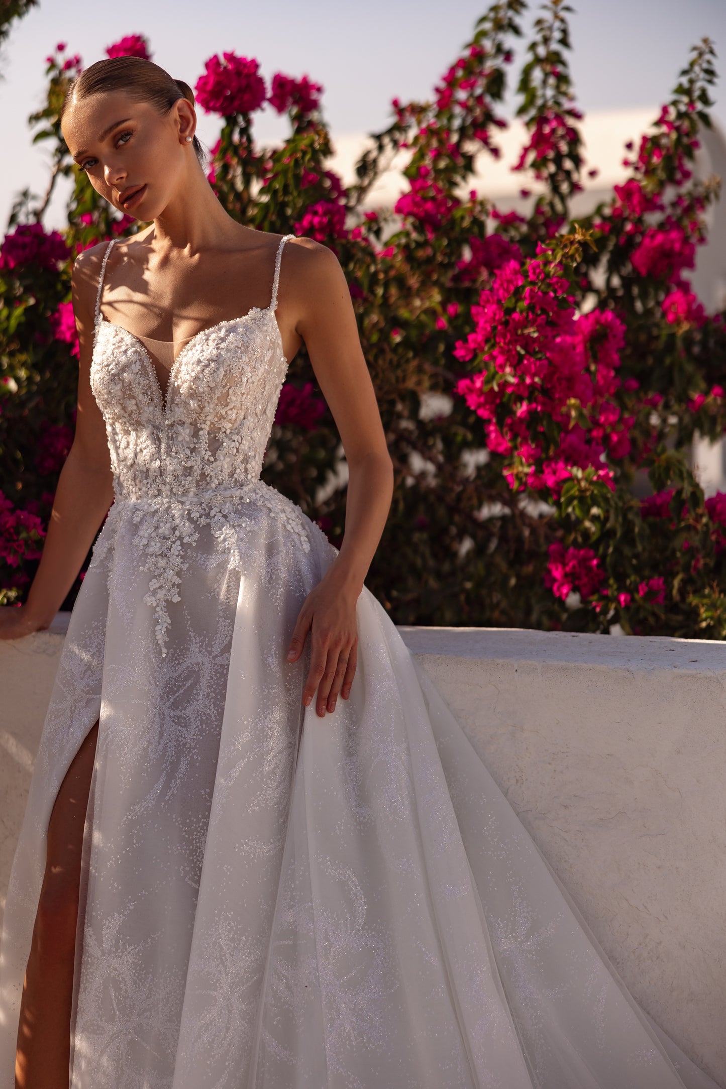 Sleeveless V-neckline A-line wedding dress with slit skirt.