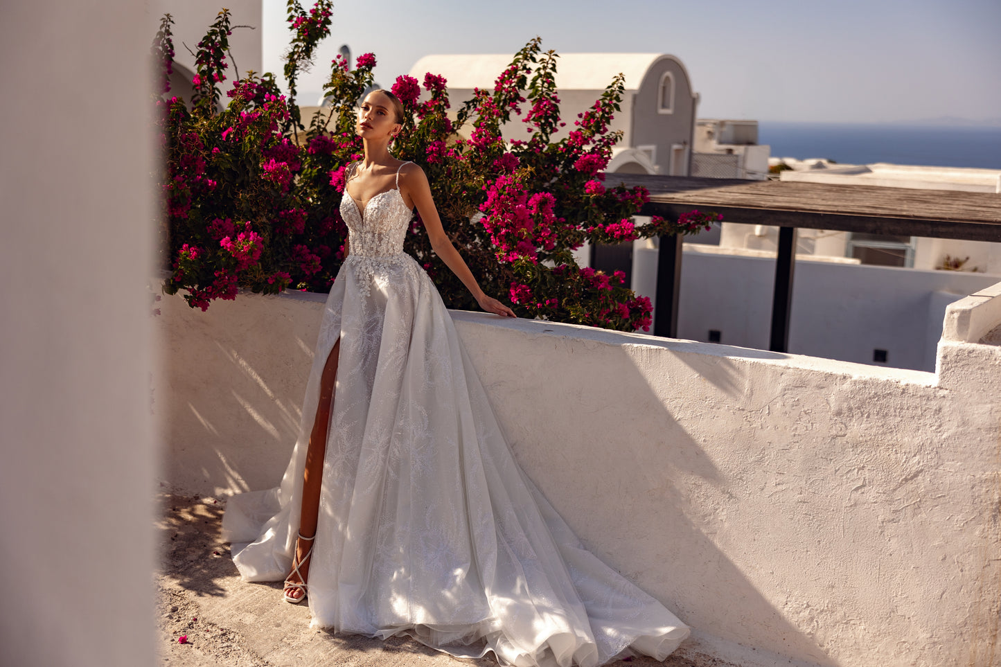 Sleeveless V-neckline A-line wedding dress with slit skirt.