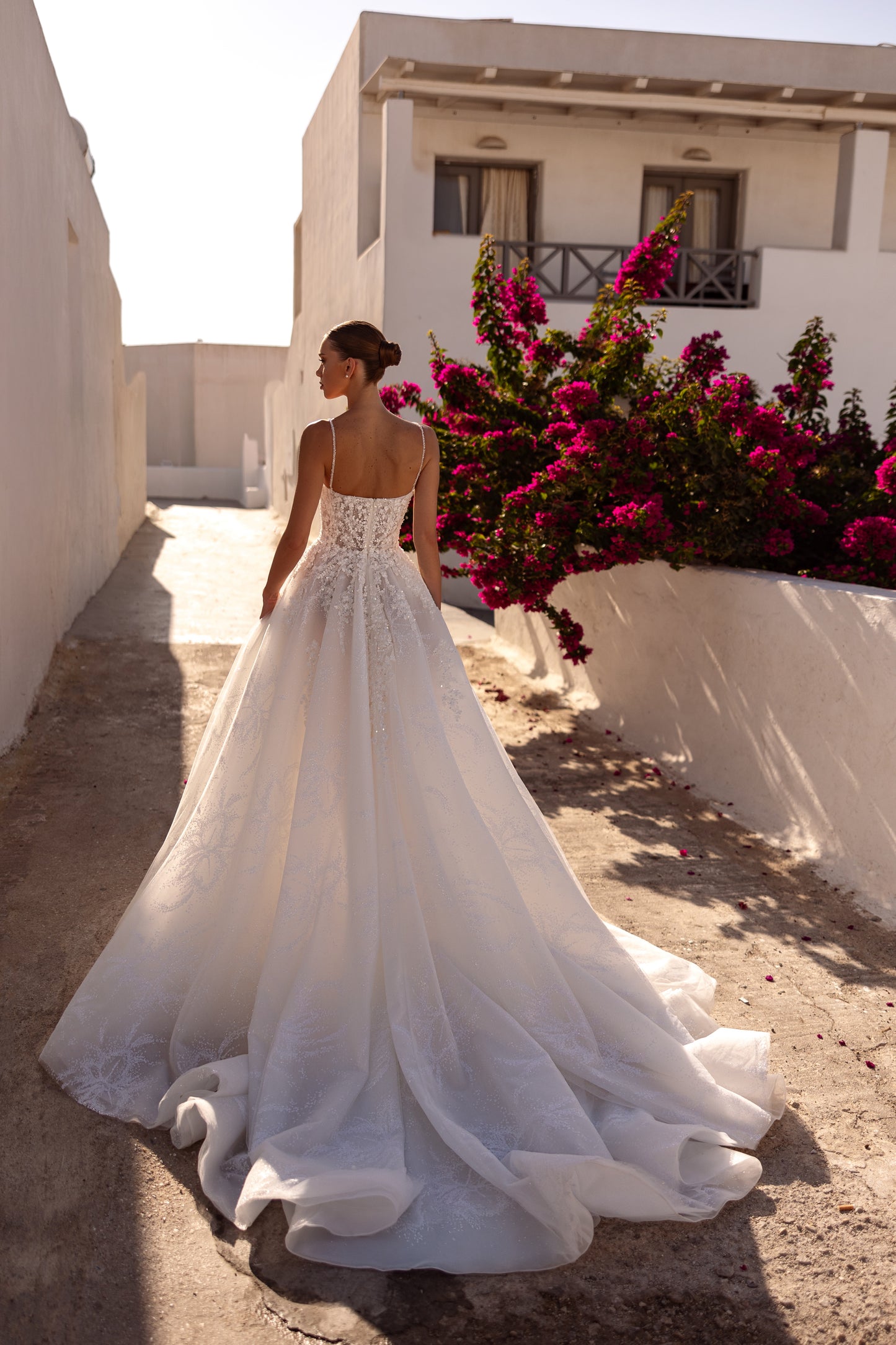 Sleeveless V-neckline A-line wedding dress with slit skirt.