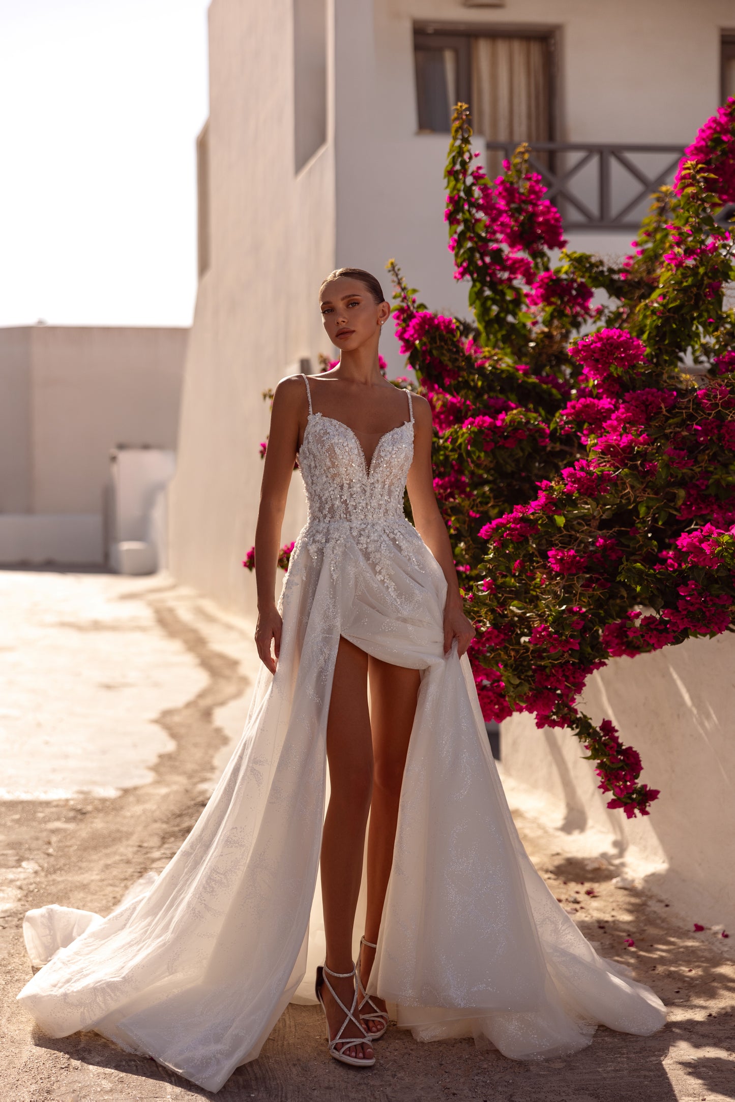Sleeveless V-neckline A-line wedding dress with slit skirt.