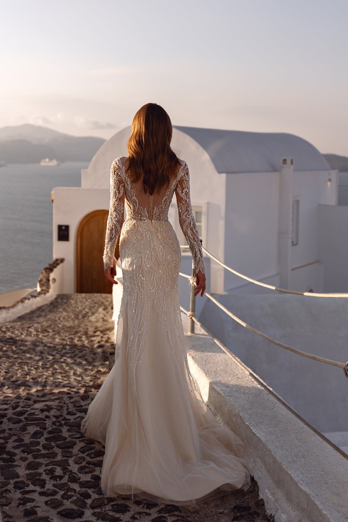 Fit and flare mermaid wedding dress with lace and long sleeves