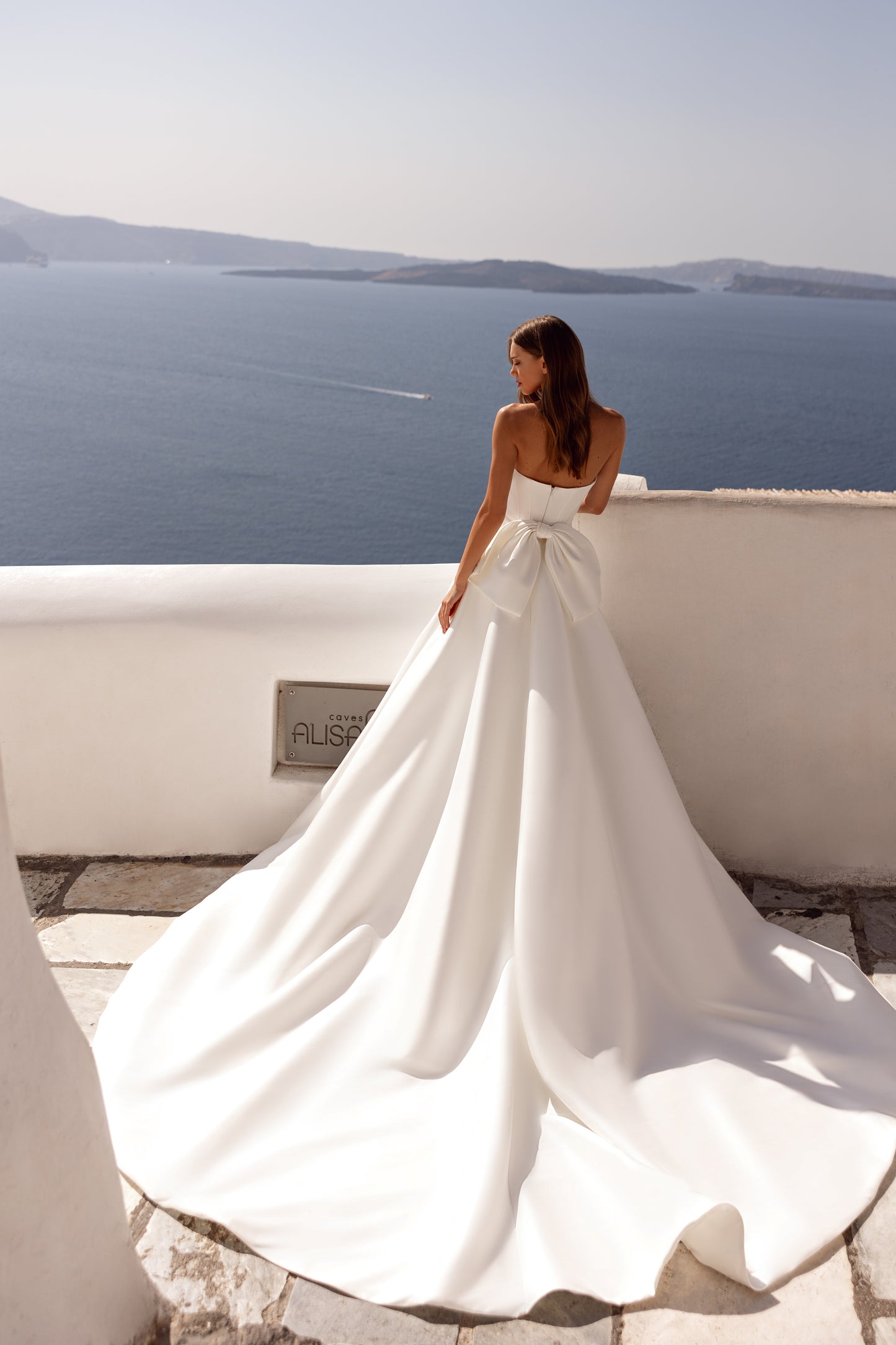 Fitted sheath wedding dress with off-the-shoulder straps.