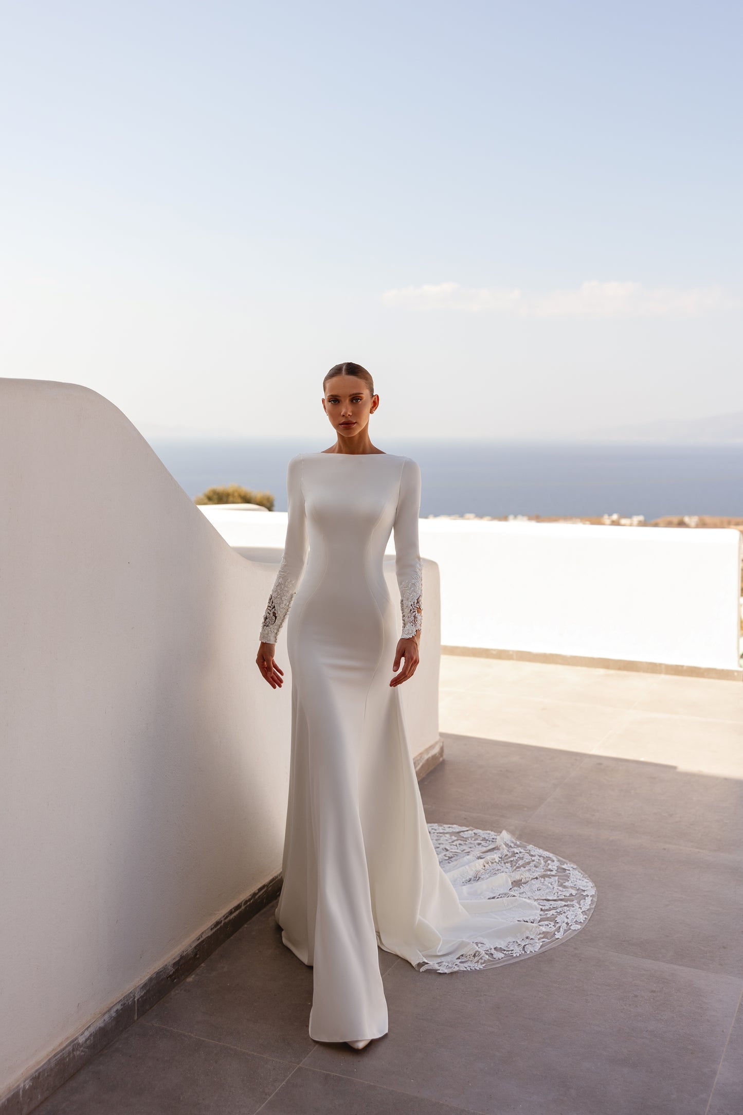 A-line wedding dress with long sleeves and open deep-V back.