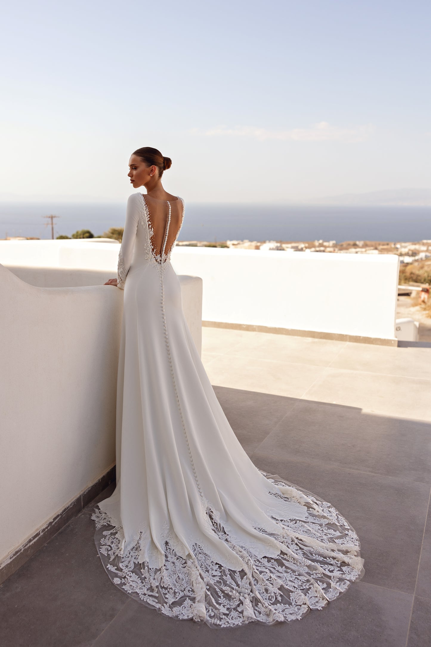 A-line wedding dress with long sleeves and open deep-V back.
