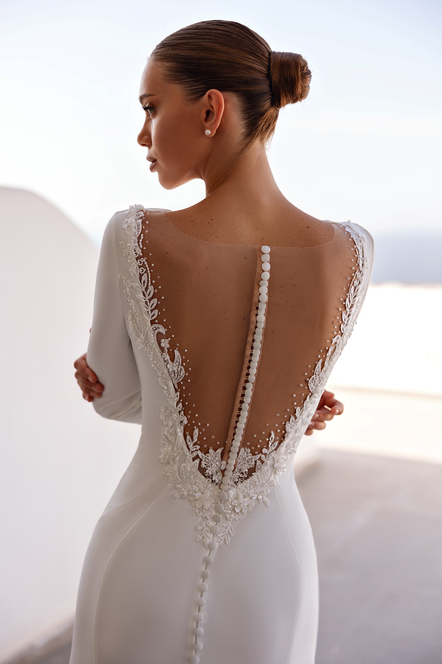 A-line wedding dress with long sleeves and open deep-V back.