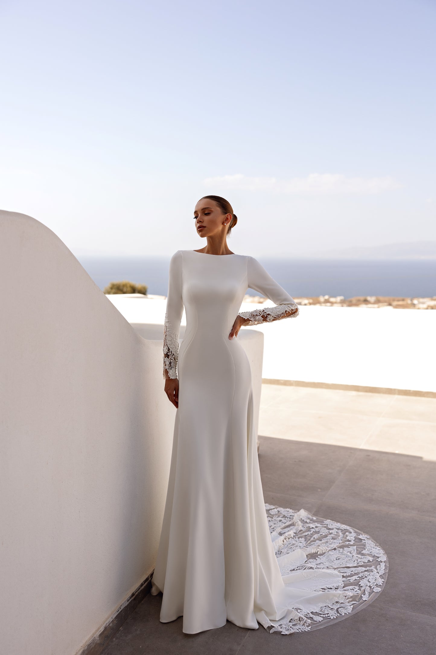 A-line wedding dress with long sleeves and open deep-V back.
