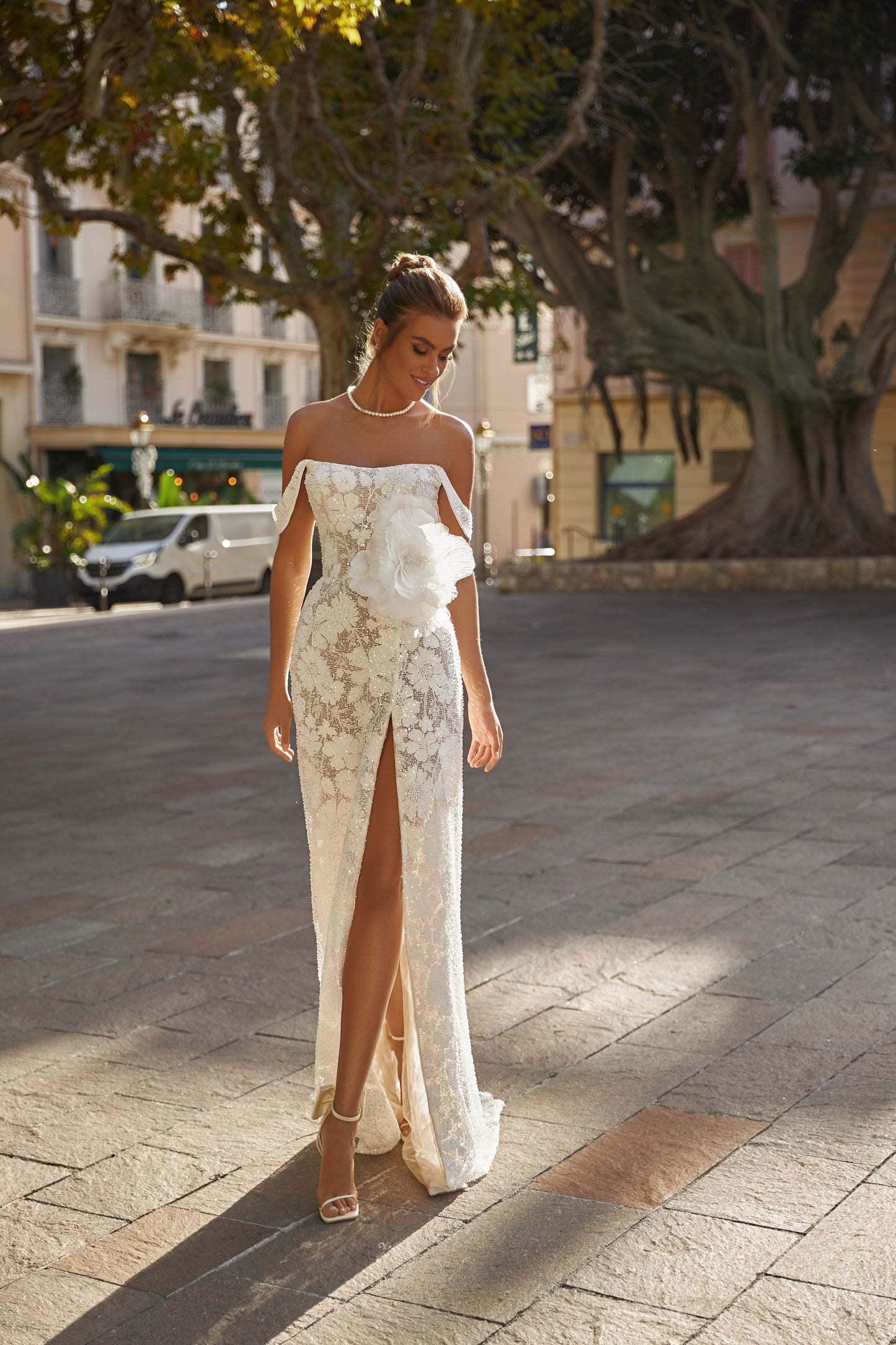 Sheath wedding dress with lace, boat neckline & slit skirt.