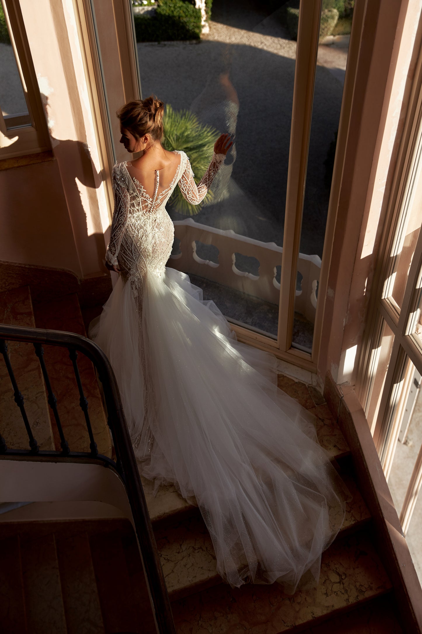 Chantilly Lace Bridal Gown with V-neckline and long sleeves.
