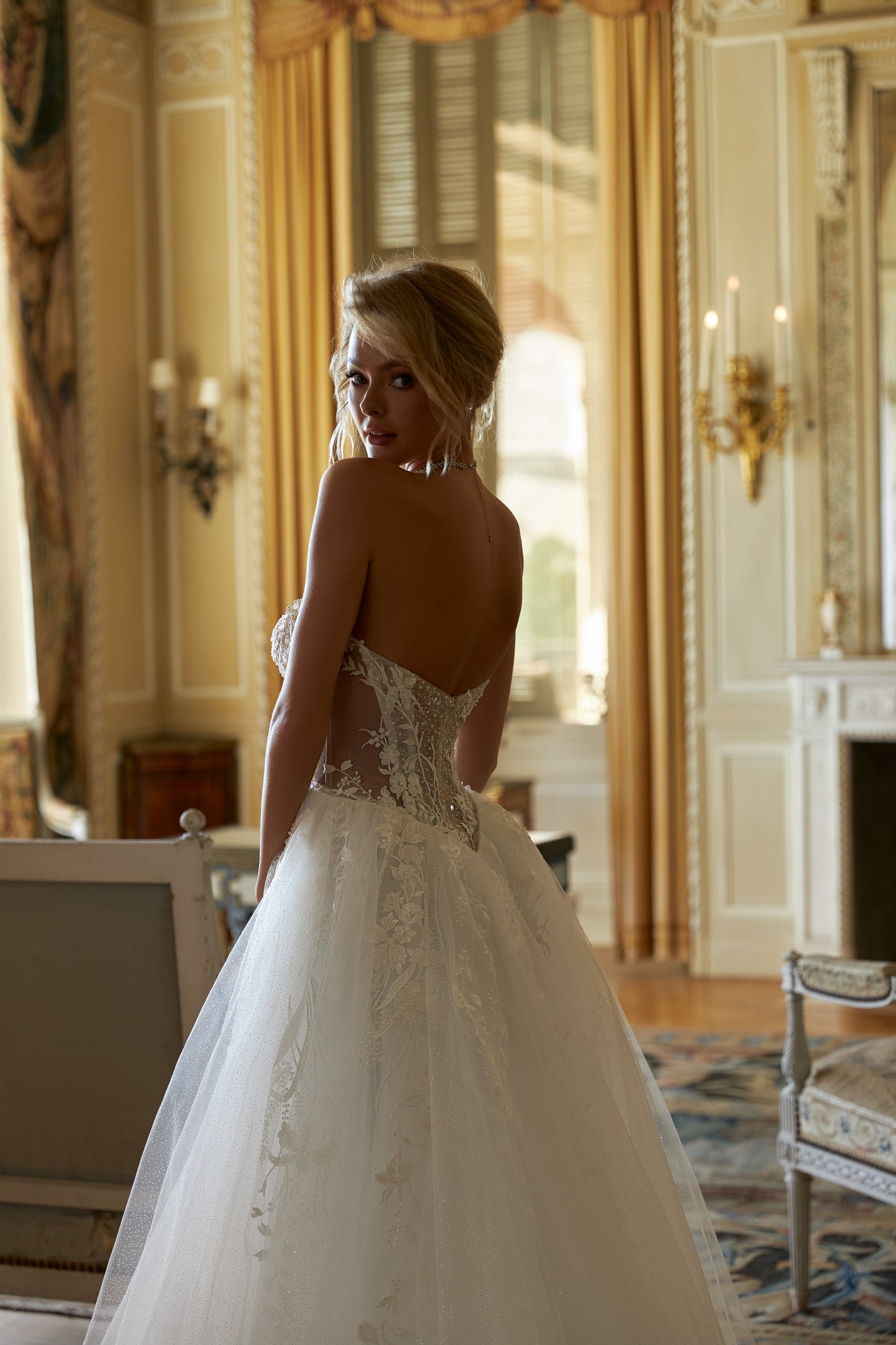 Fitted mermaid lace wedding dress with halter neckline.