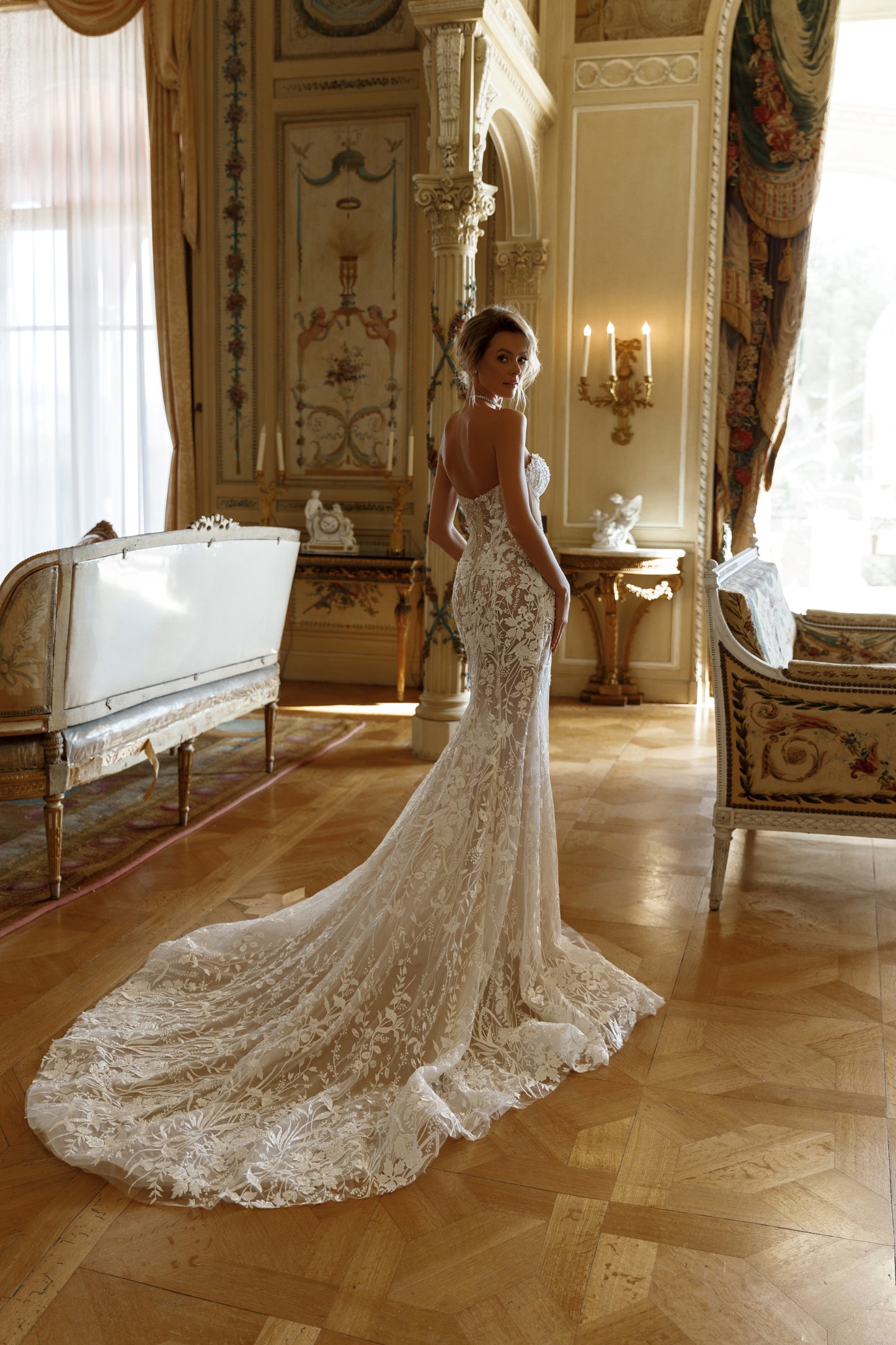 Fitted mermaid lace wedding dress with halter neckline.