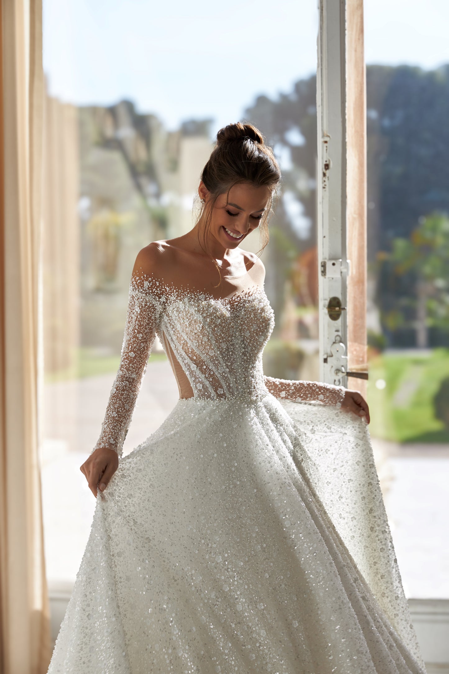 A-line wedding dress with illusion sleeves and sequin details.