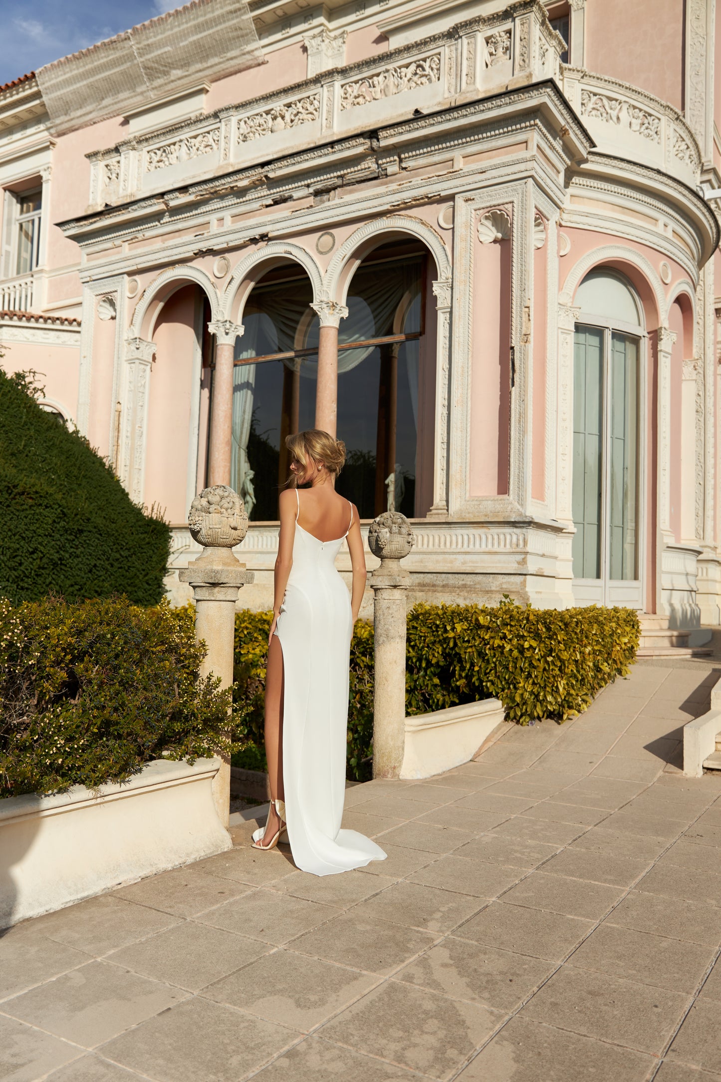 Sheath wedding dress with slit skirt and sweep train gown.