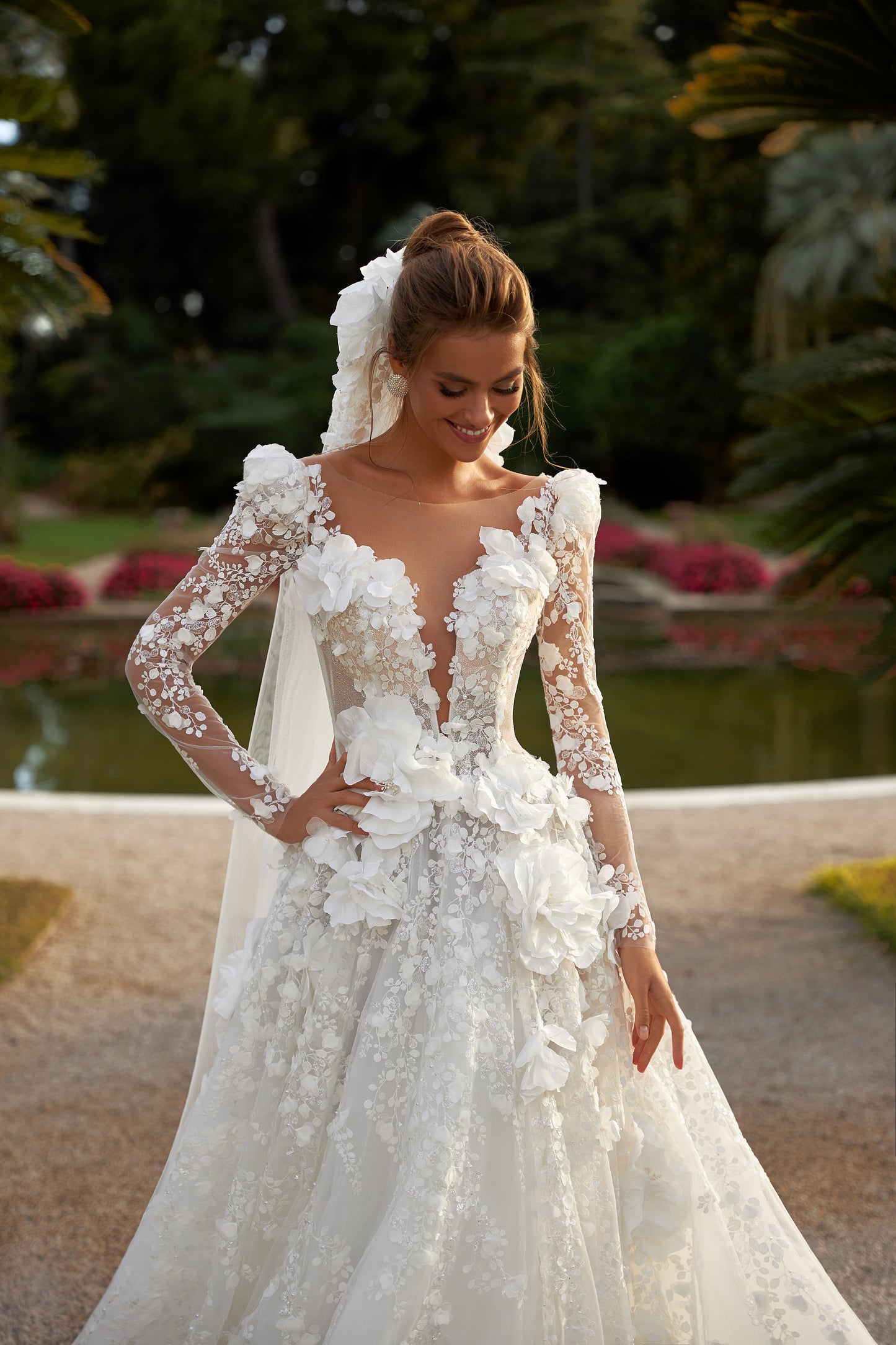 A-line wedding dress with deep V-neckline & illusion sleeves.