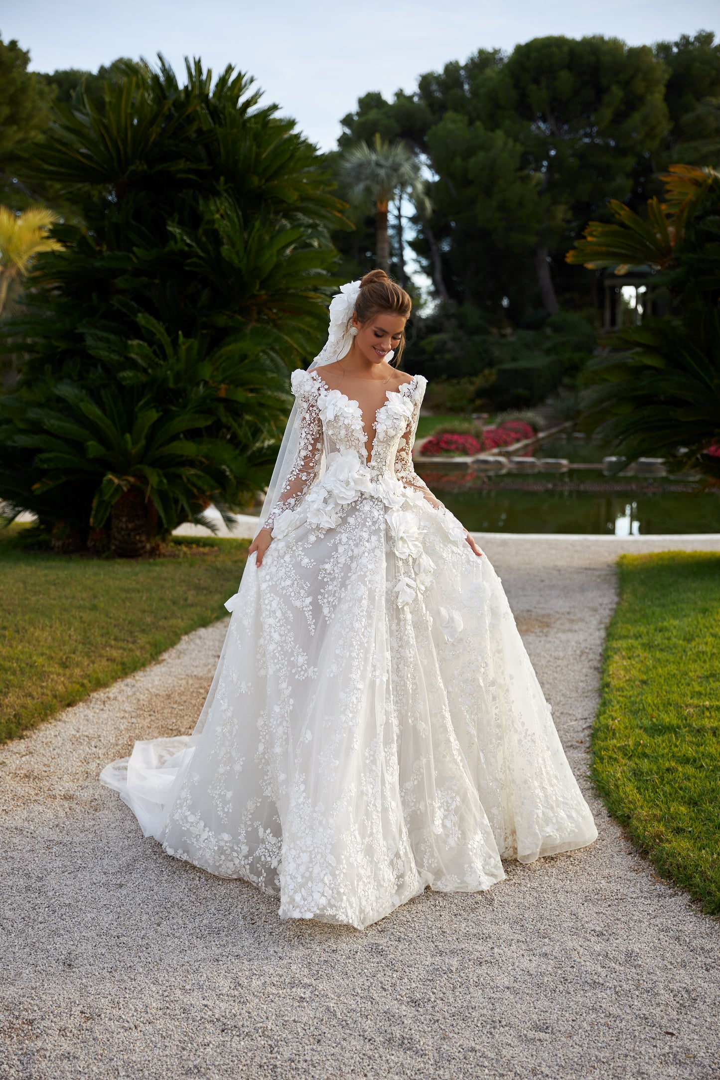 A-line wedding dress with deep V-neckline & illusion sleeves.
