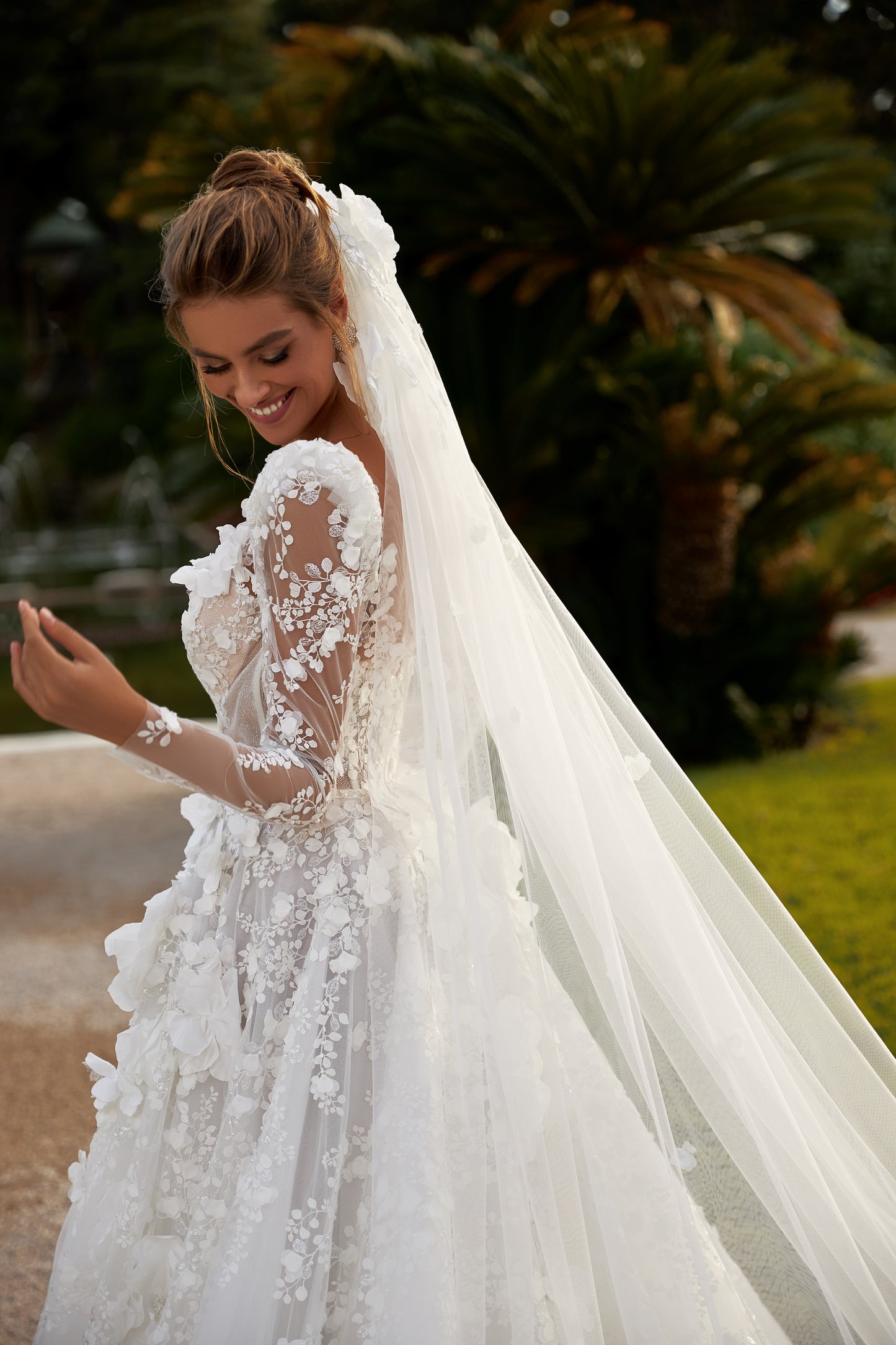 A-line wedding dress with deep V-neckline & illusion sleeves.