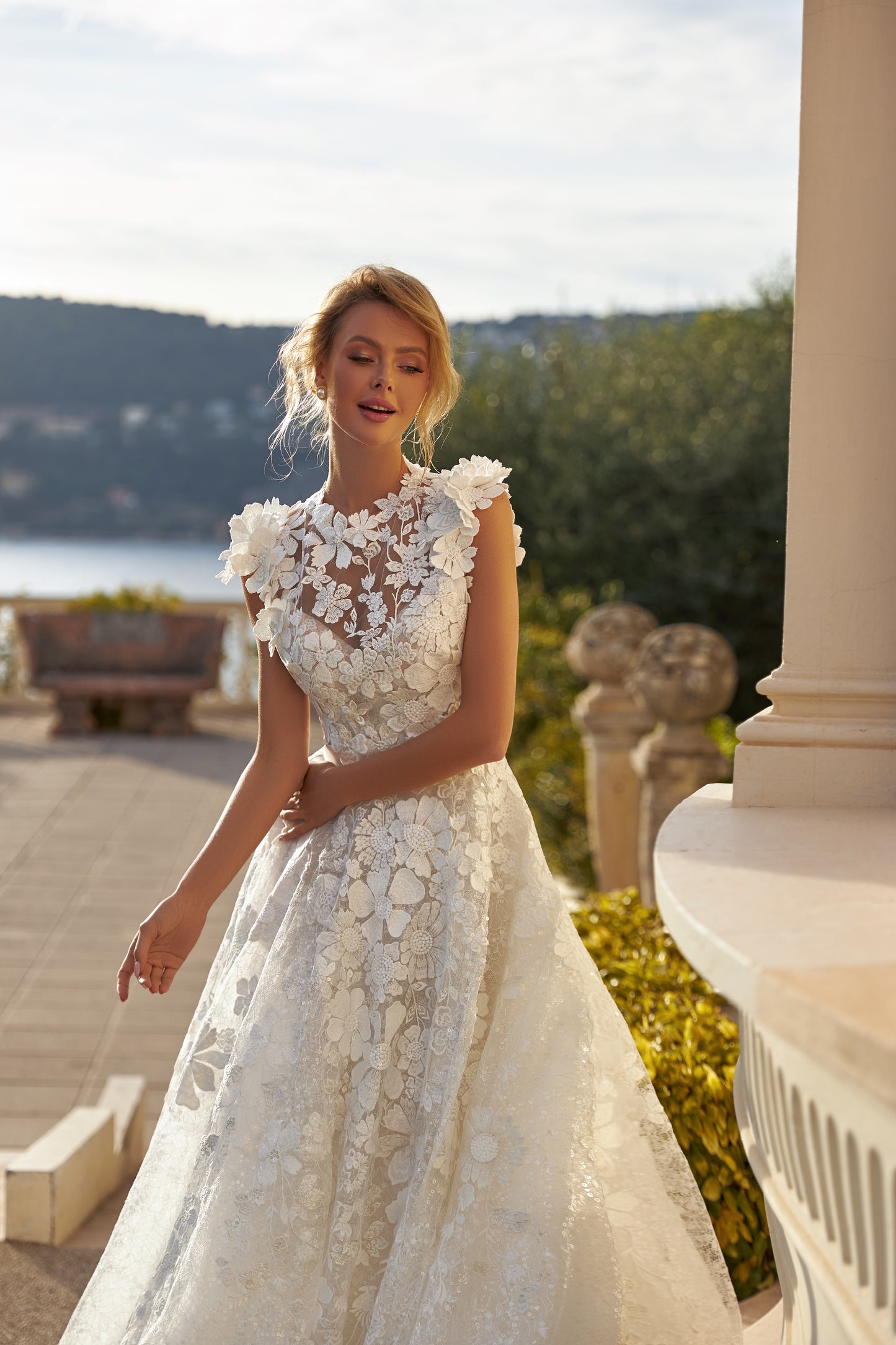 A-line lace wedding dress with cape and beaded details.