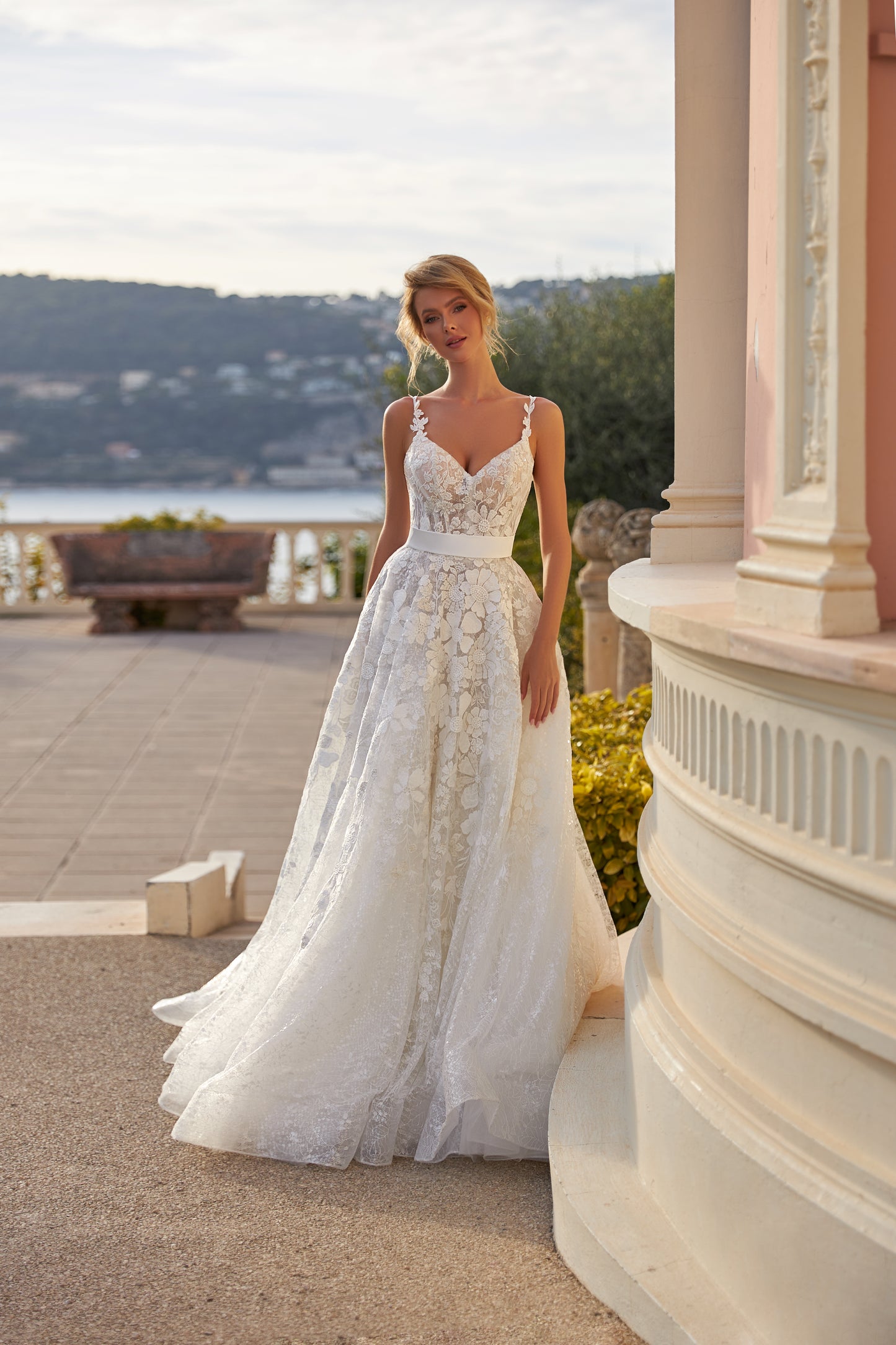 A-line lace wedding dress with cape and beaded details.