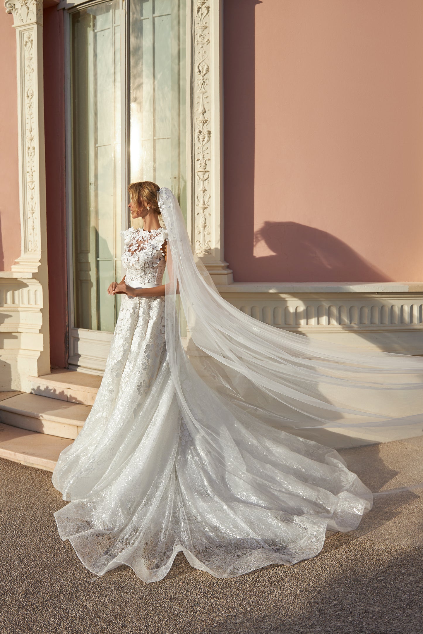 A-line lace wedding dress with cape and beaded details.