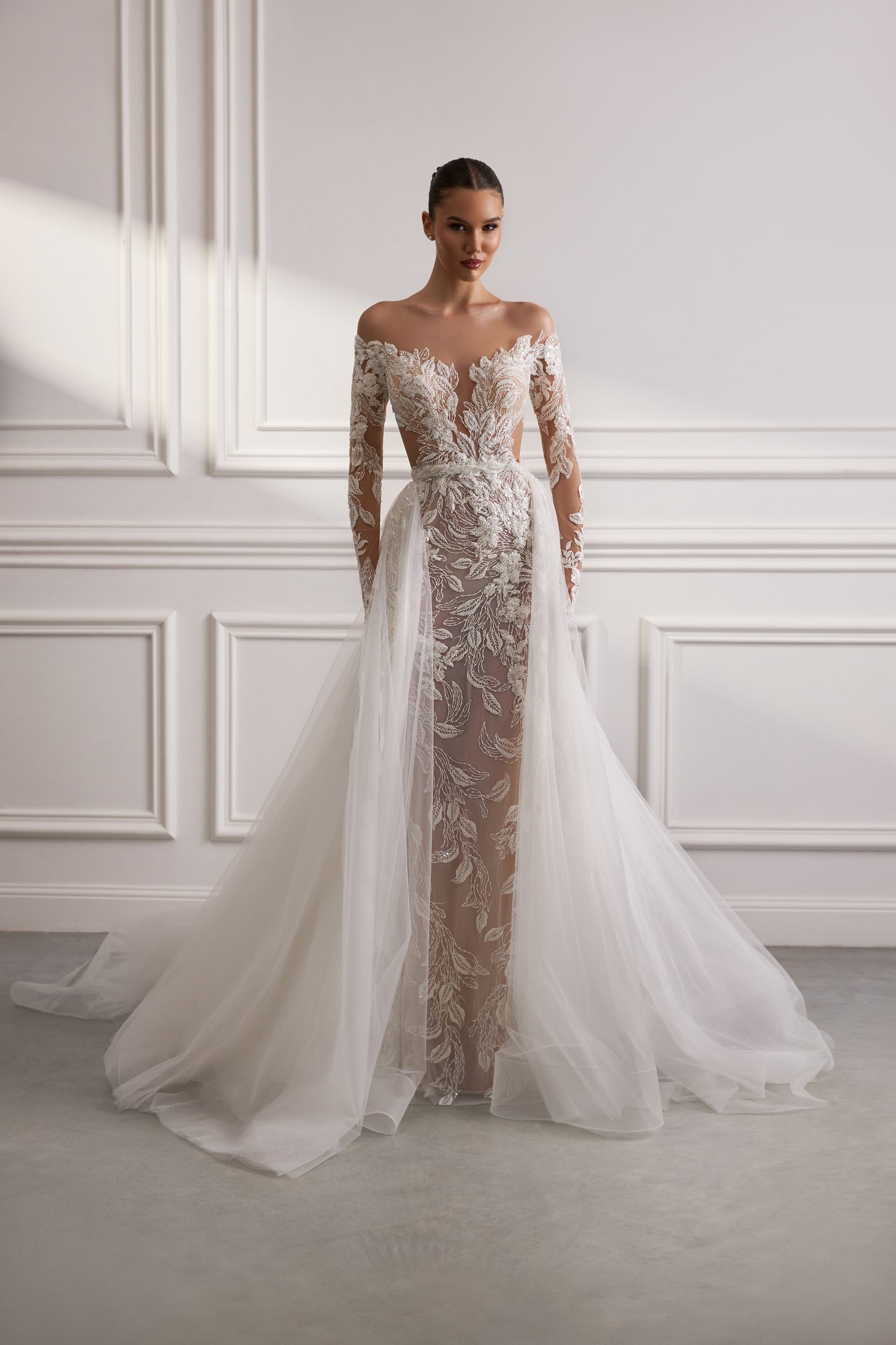 Sheath wedding dress with illusion sleeves and sweep train.