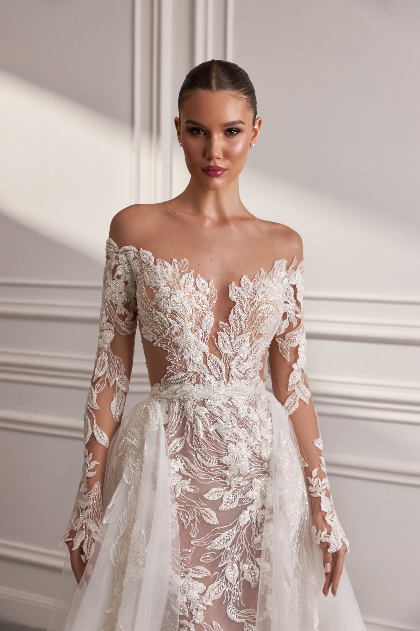 Sheath wedding dress with illusion sleeves and sweep train.