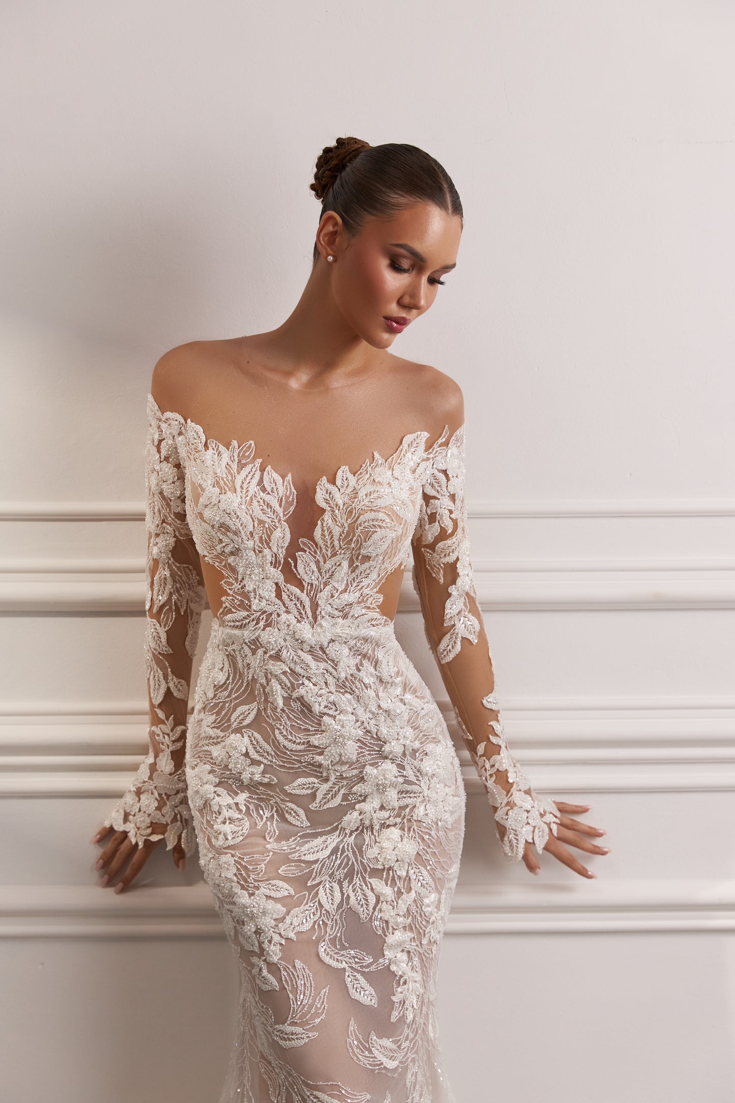 Sheath wedding dress with illusion sleeves and sweep train.