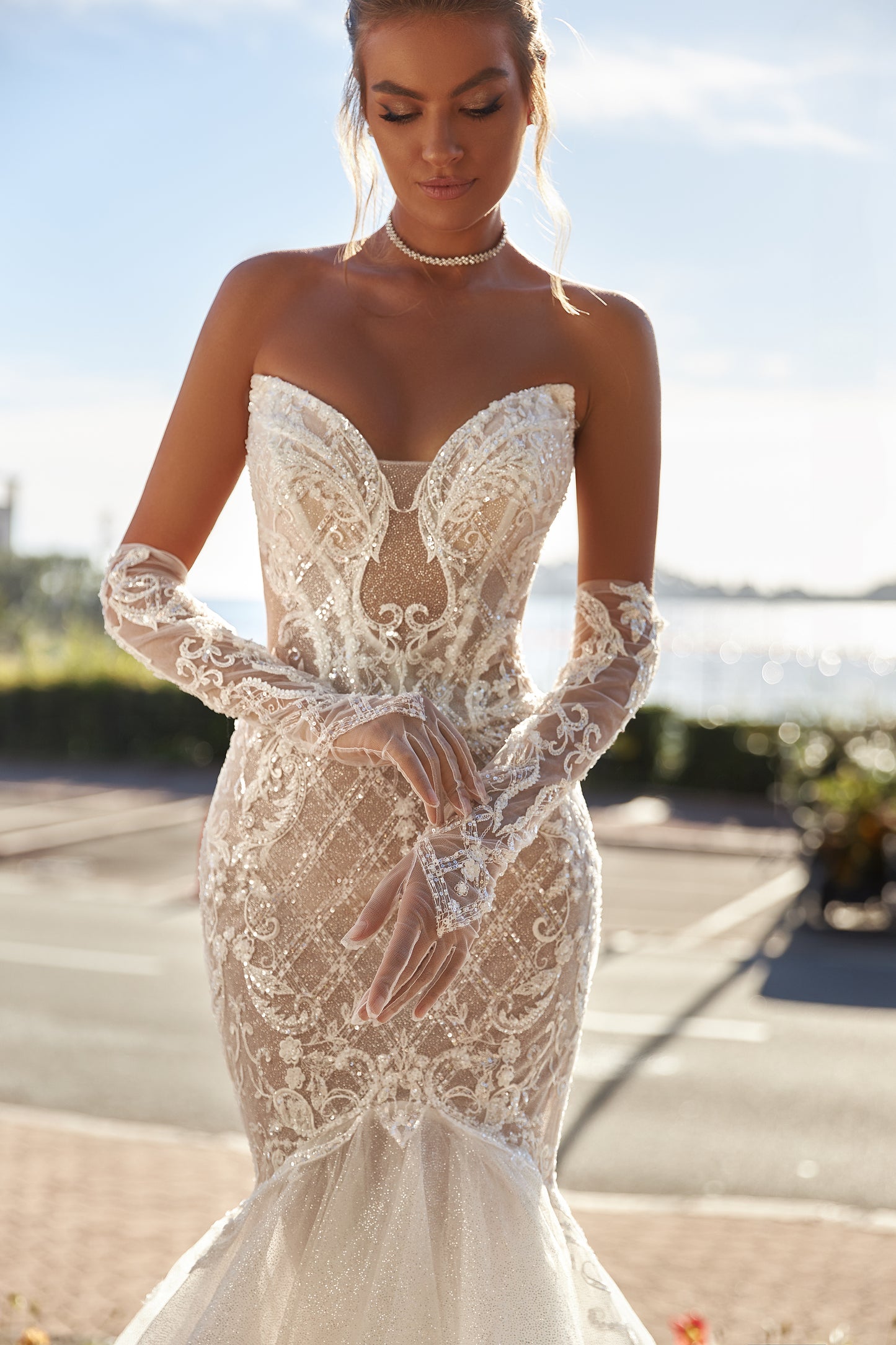 Fit-and-flare lace mermaid wedding dress with open back.