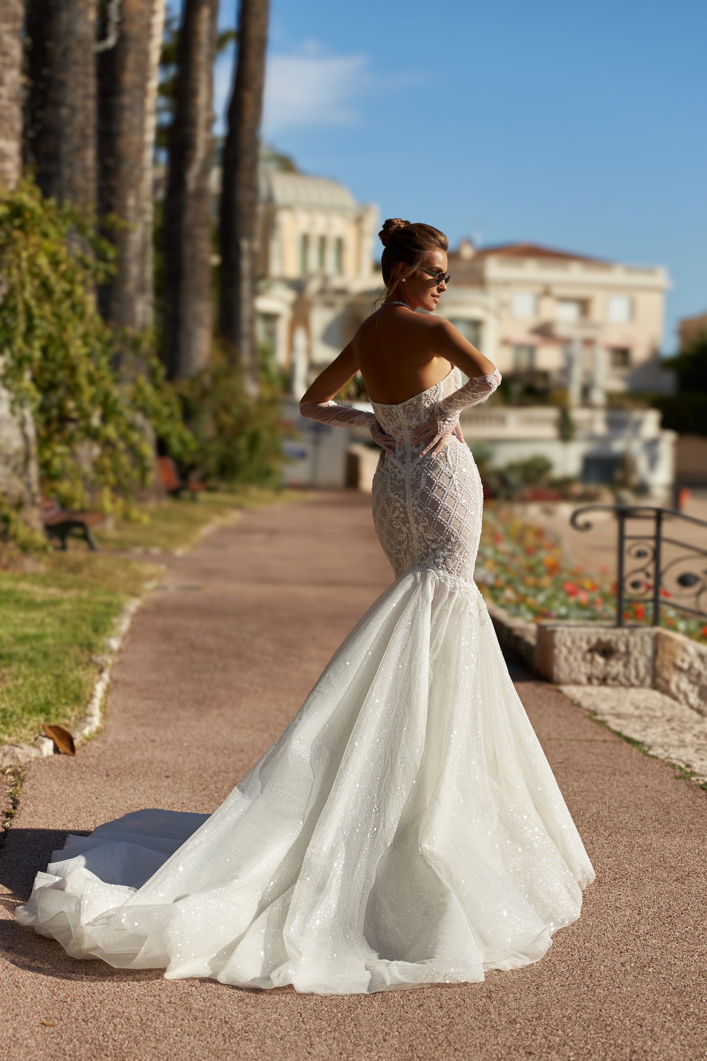 Fit-and-flare lace mermaid wedding dress with open back.