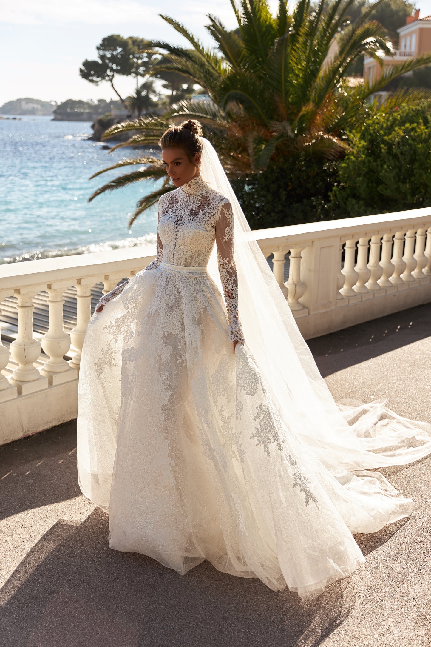 Halter wedding dress with cape and chapel train in lace.