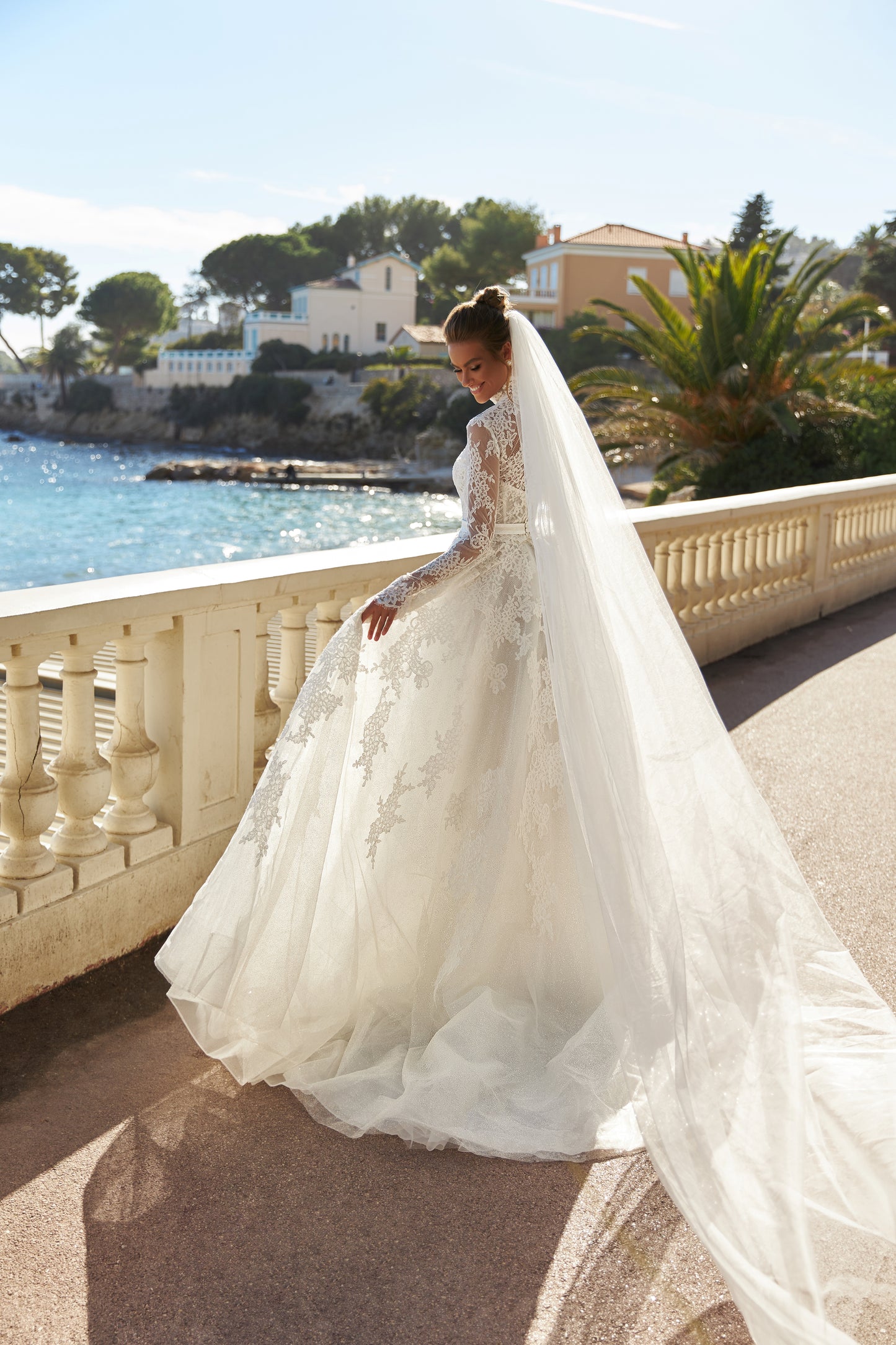 Halter wedding dress with cape and chapel train in lace.