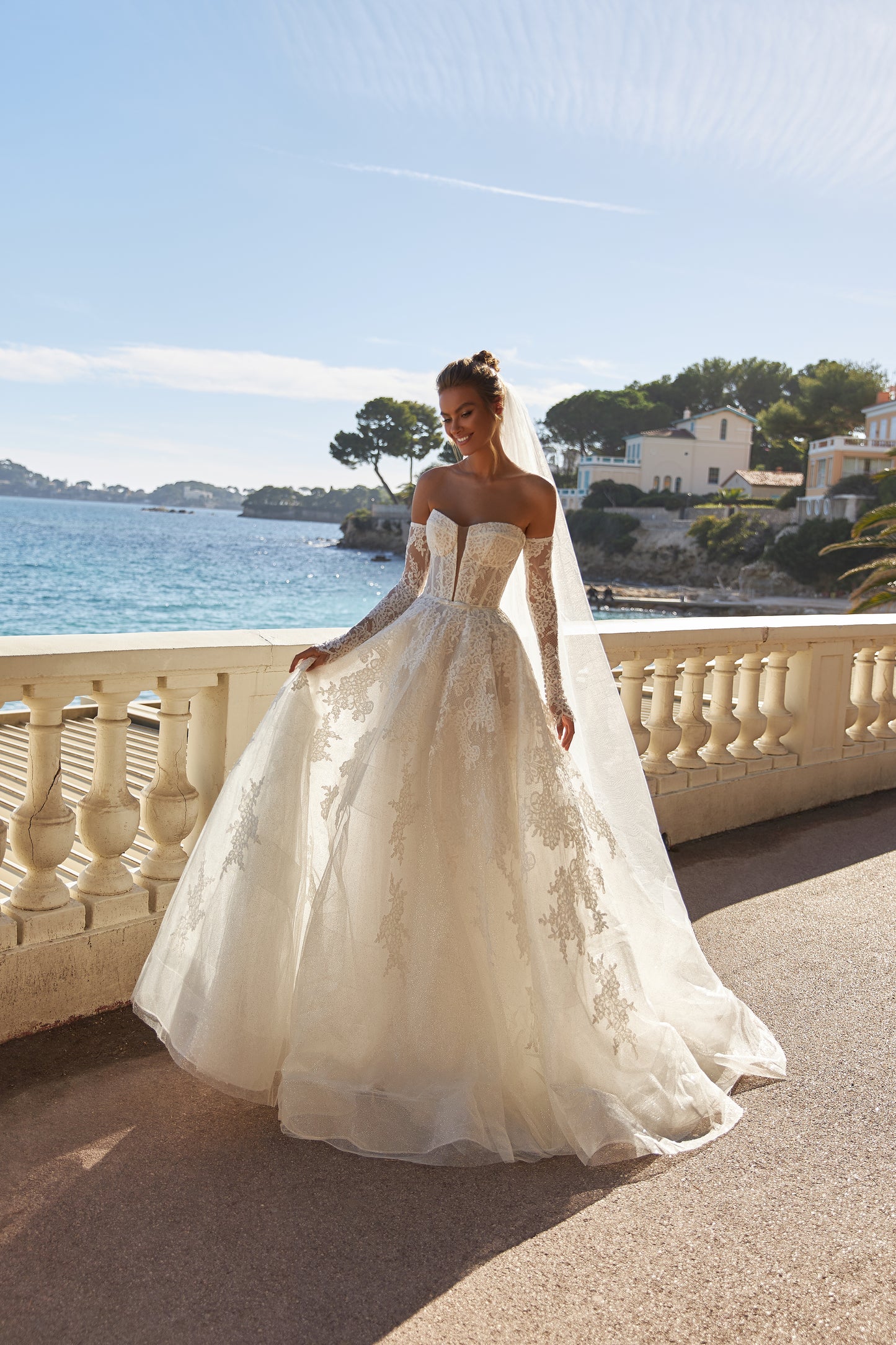 Halter wedding dress with cape and chapel train in lace.