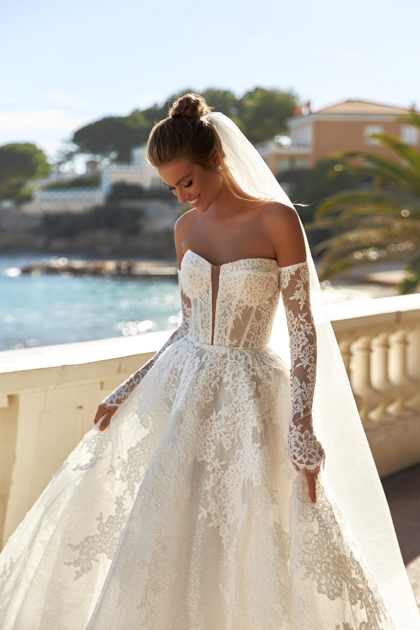 Halter wedding dress with cape and chapel train in lace.