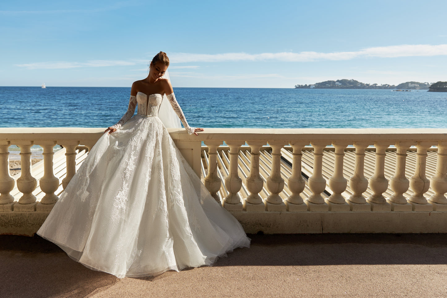 Halter wedding dress with cape and chapel train in lace.