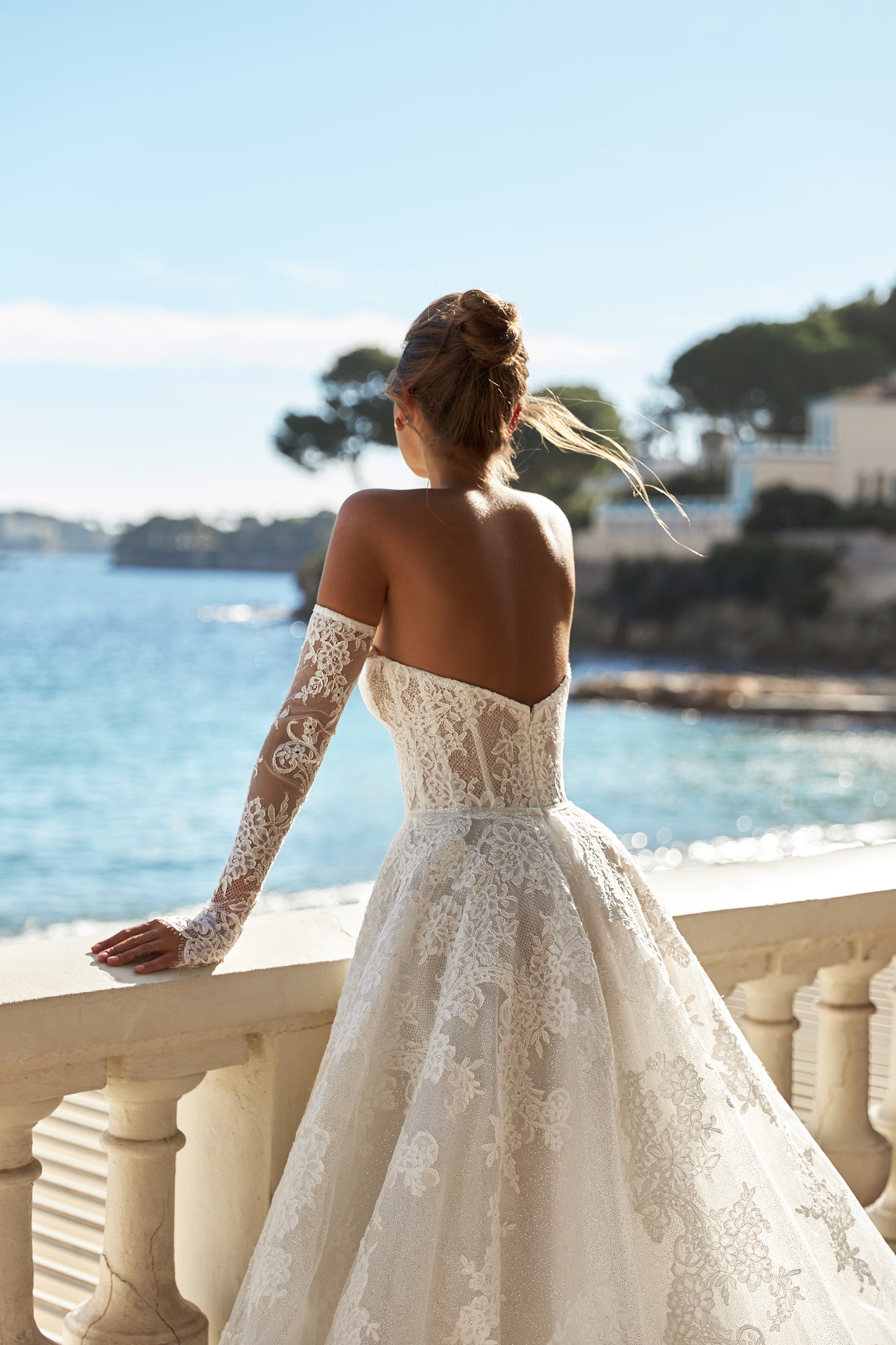 Halter wedding dress with cape and chapel train in lace.