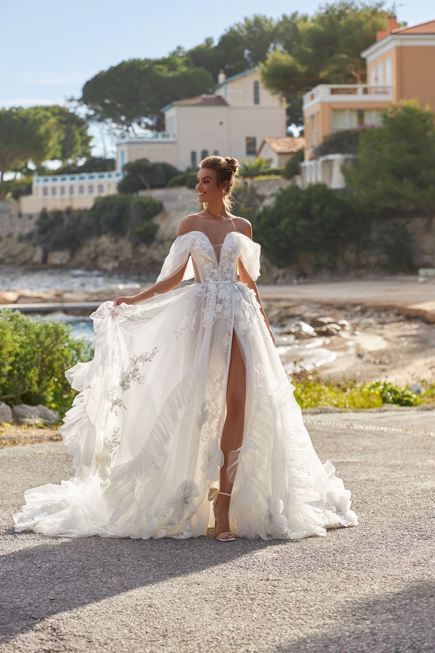 A-line tulle wedding dress with chapel train and wrap skirt.