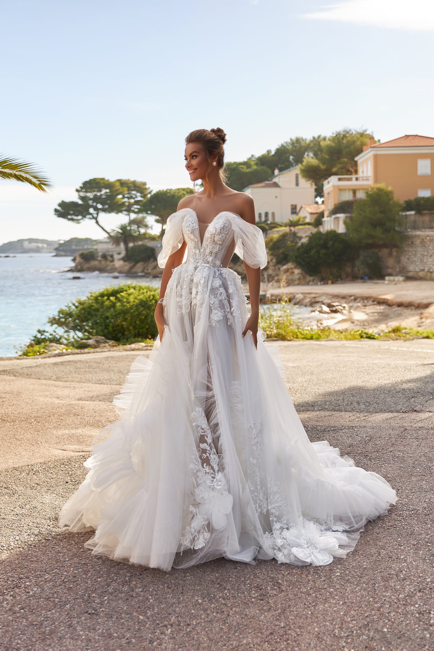 A-line tulle wedding dress with chapel train and wrap skirt.