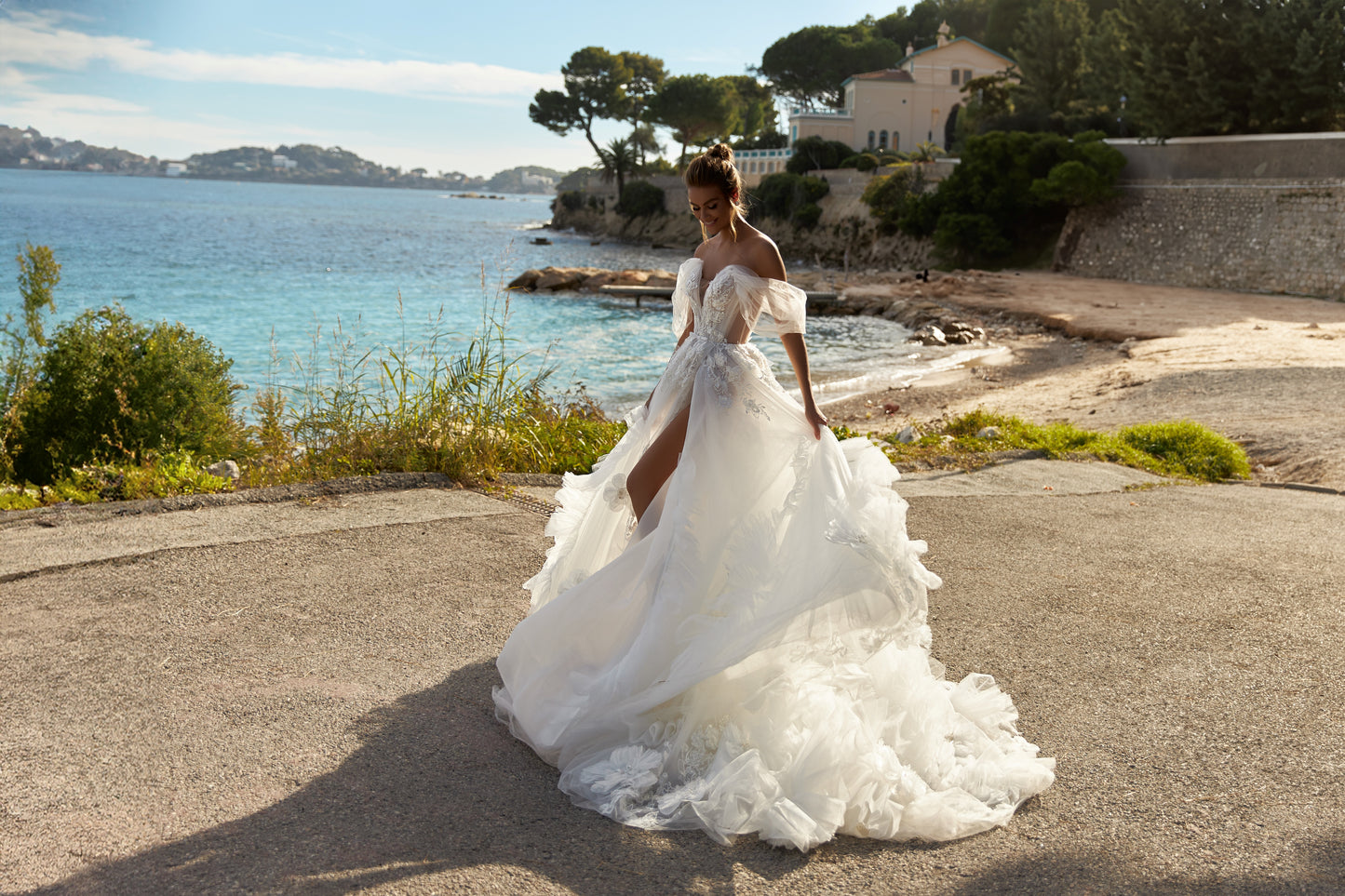 A-line tulle wedding dress with chapel train and wrap skirt.