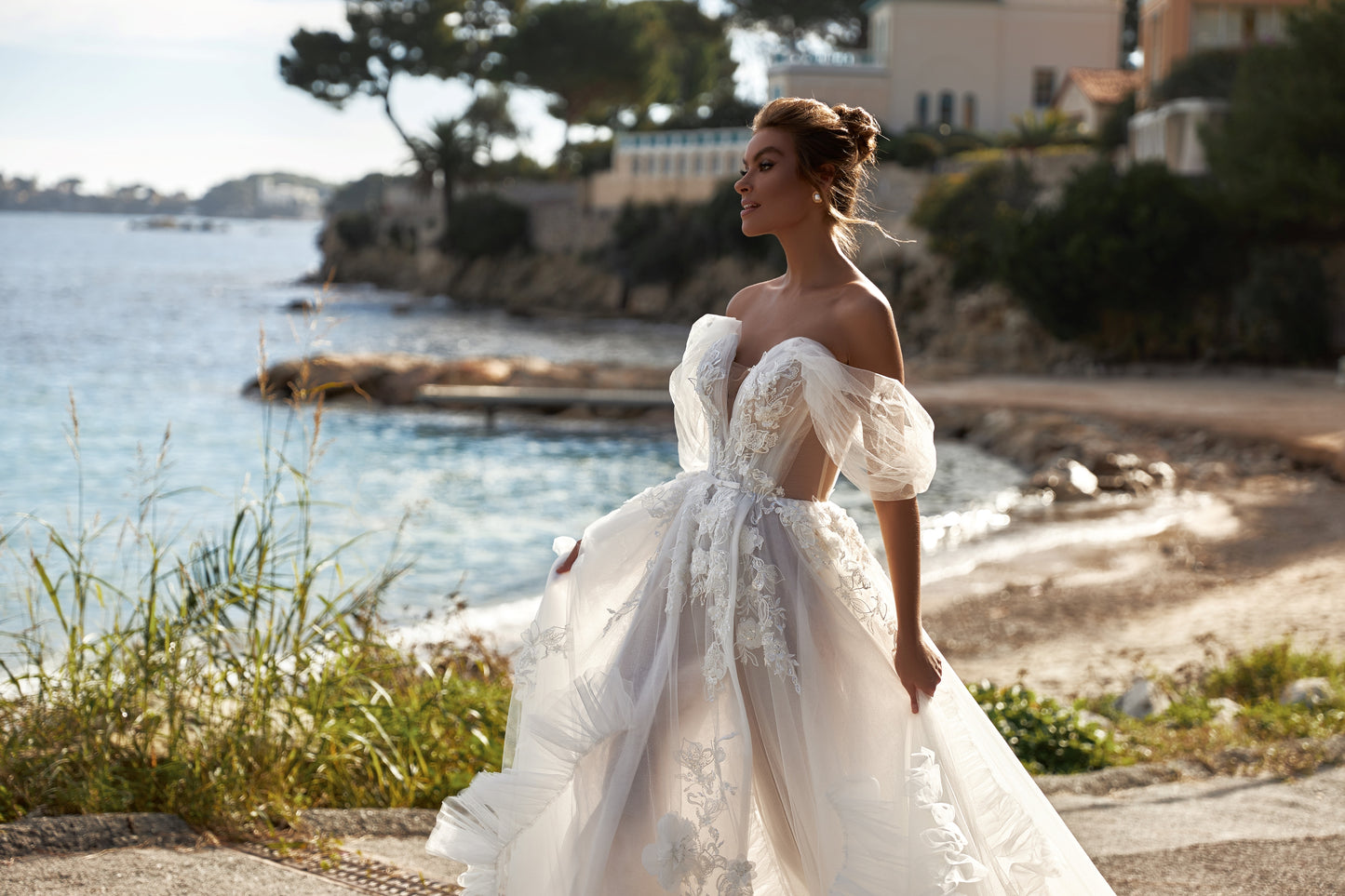 A-line tulle wedding dress with chapel train and wrap skirt.