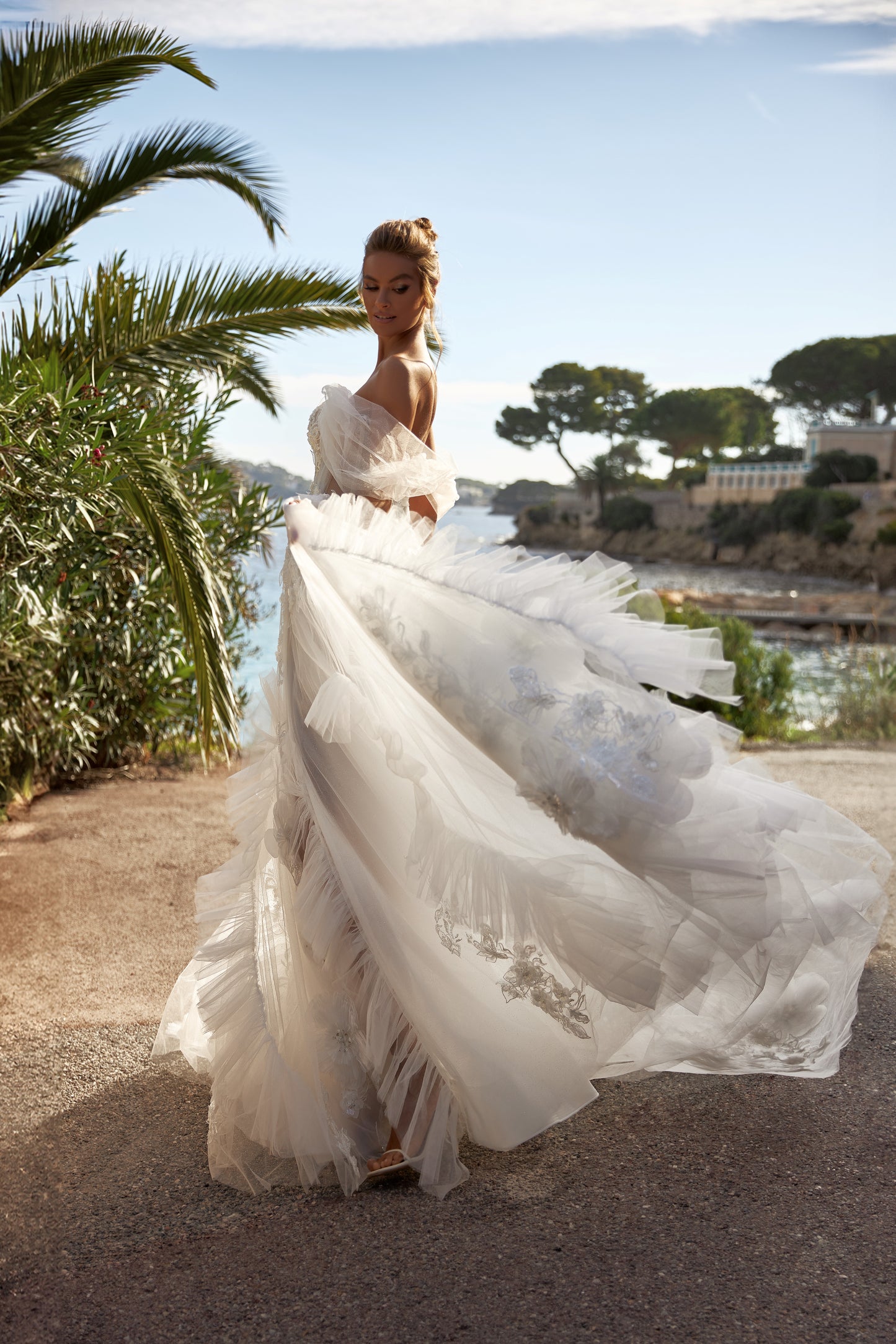 A-line tulle wedding dress with chapel train and wrap skirt.