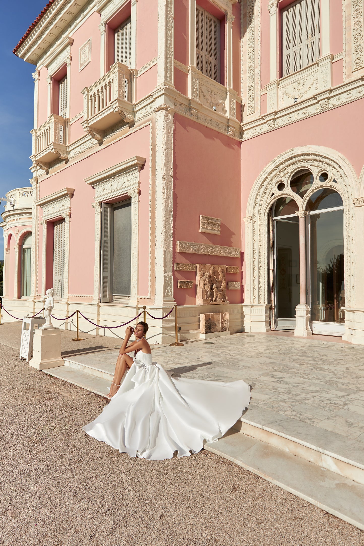 Ivory A-line sleeveless wedding dress with open back & bow.