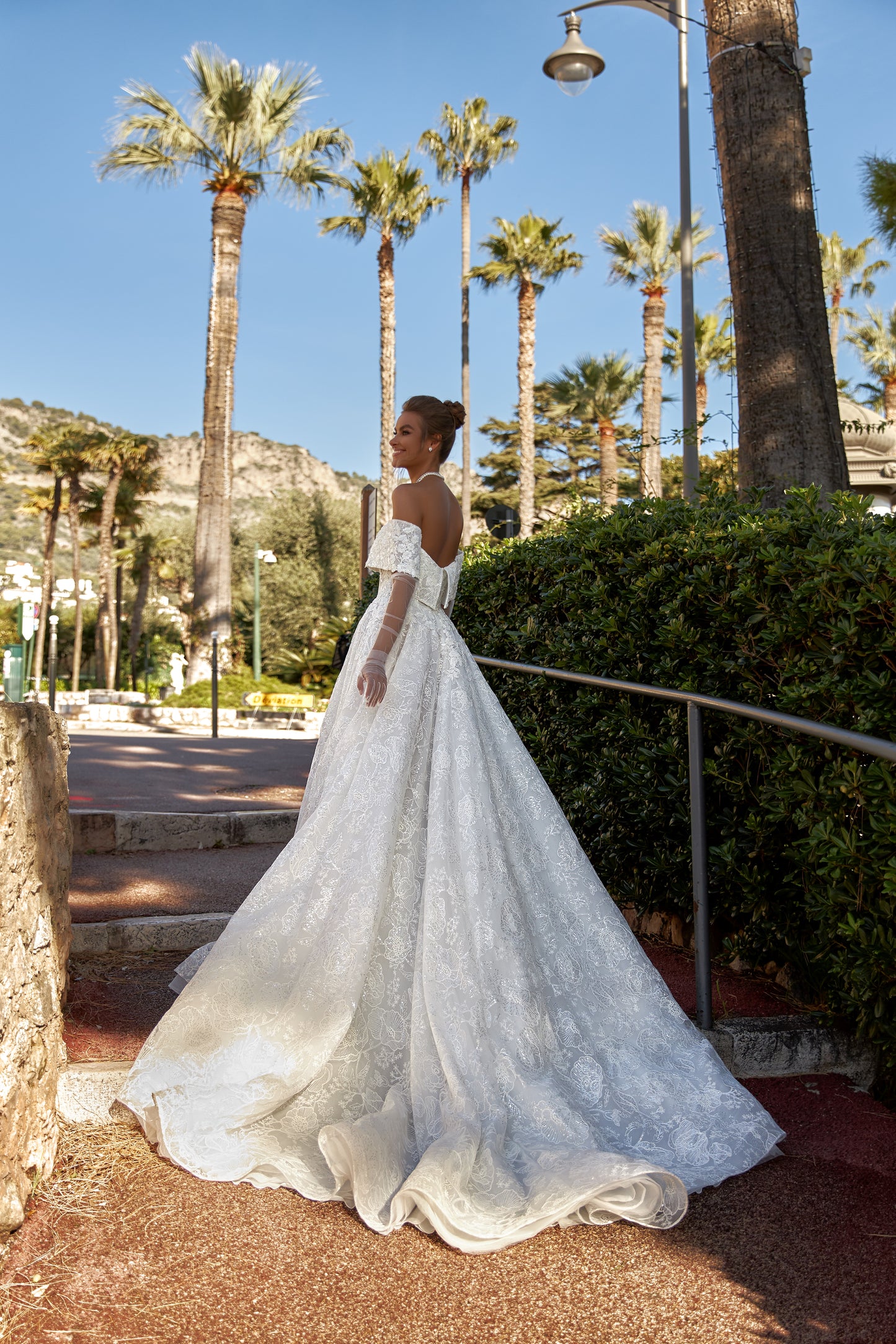 A-line lace wedding dress with chapel train & deep-V neckline.