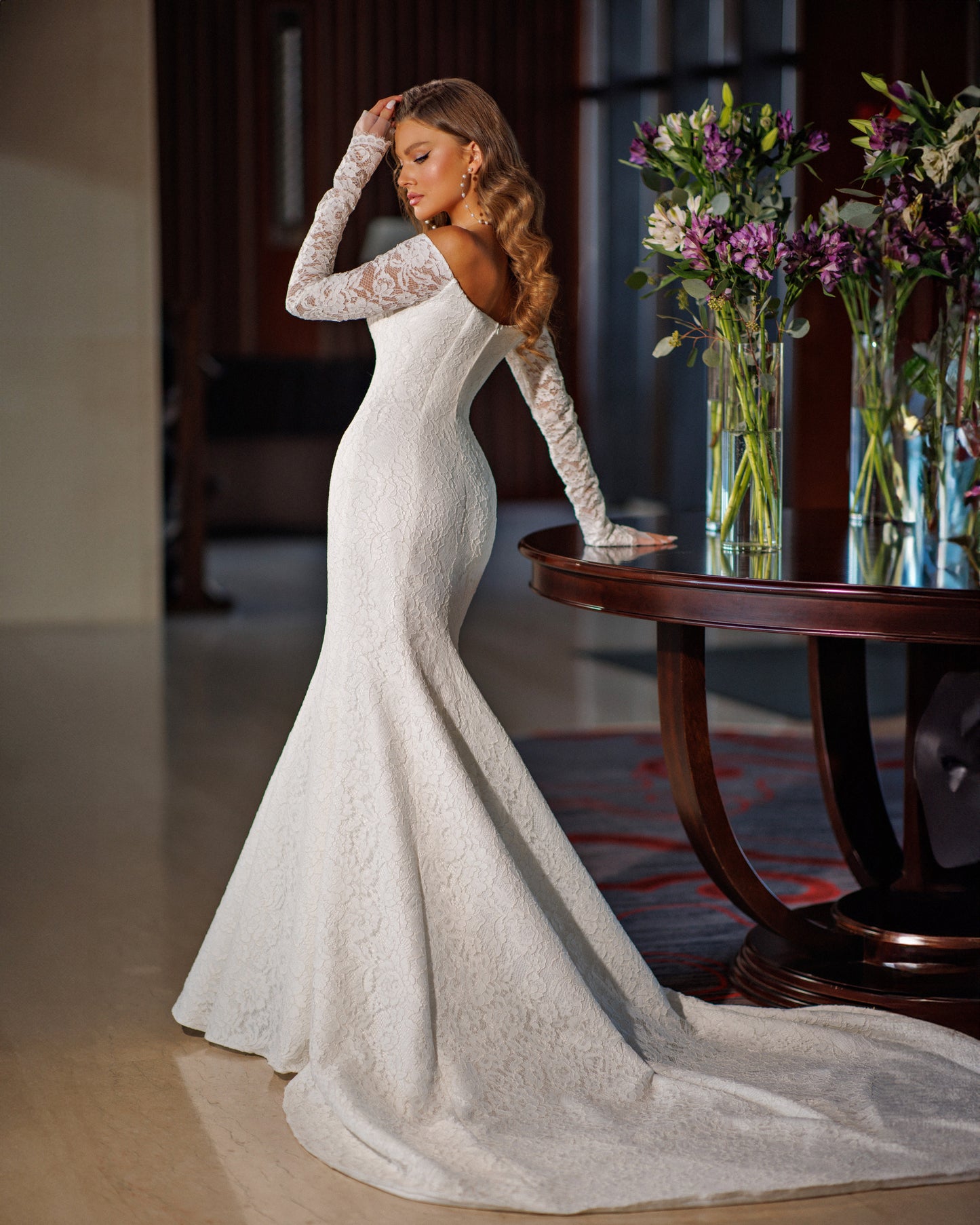 Off the shoulder lace mermaid wedding dress with long sleeves.