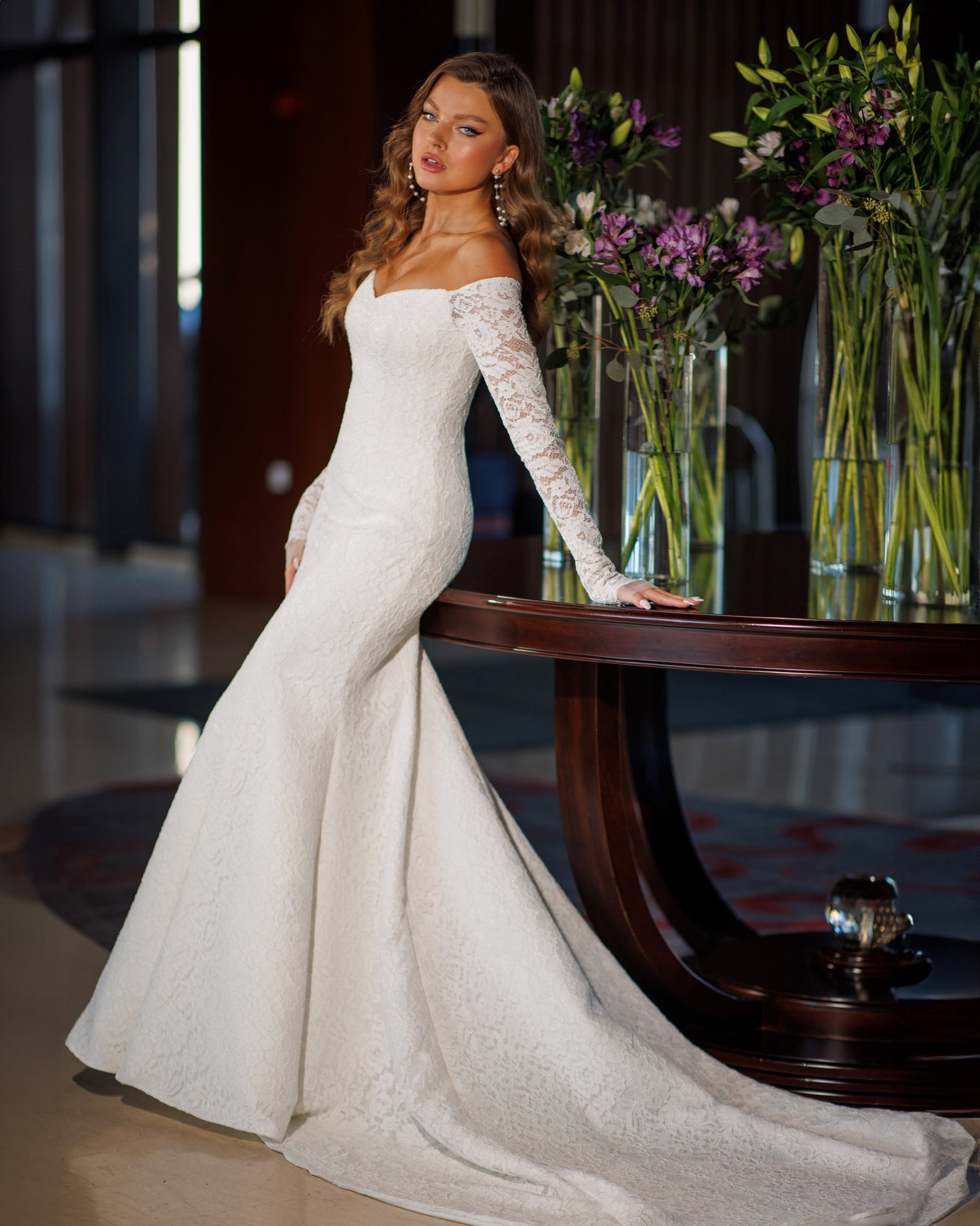 Off the shoulder lace mermaid wedding dress with long sleeves.