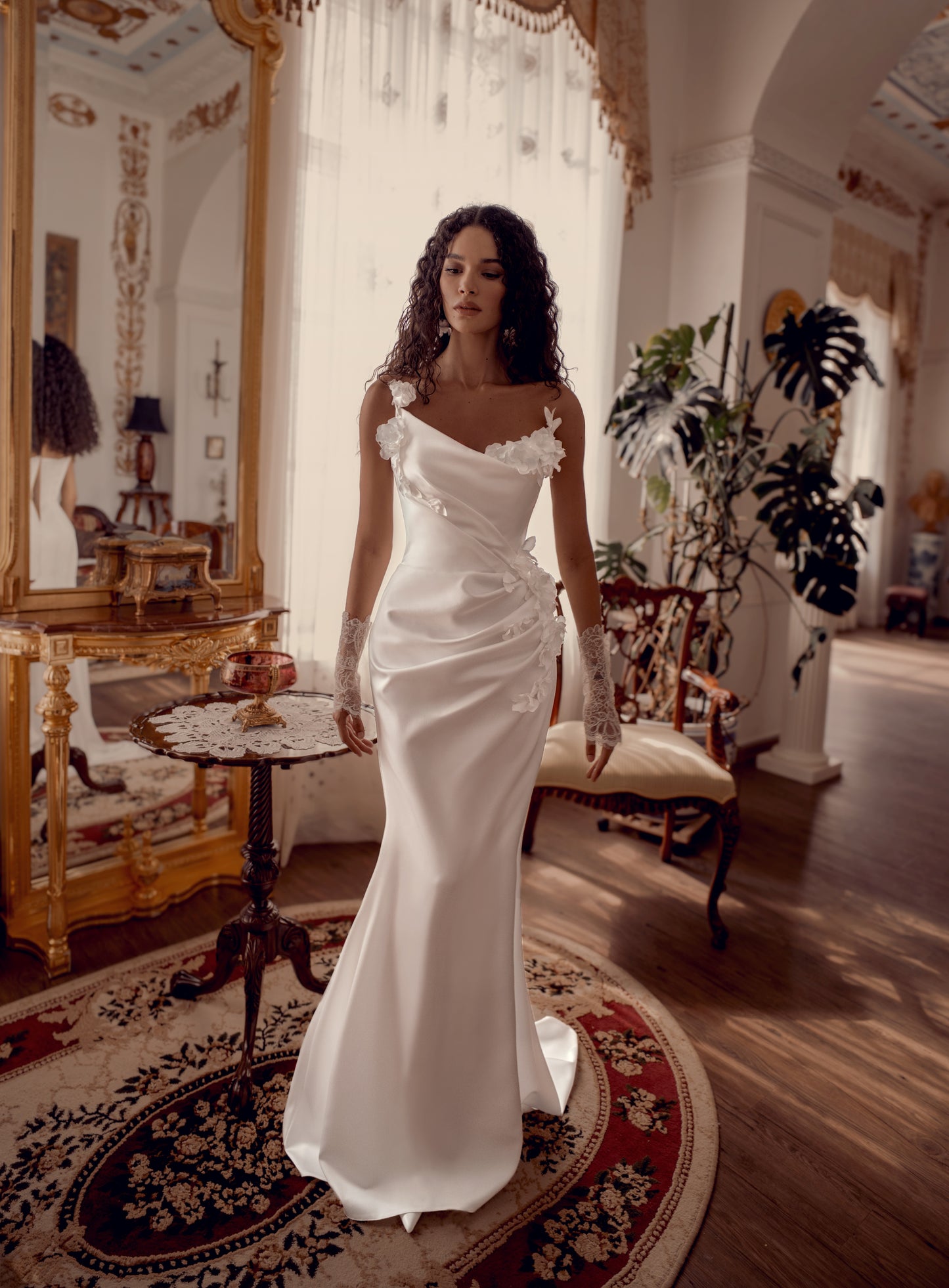 Silk satin wedding gown with asymmetric draped neckline and 3D floral appliqué.