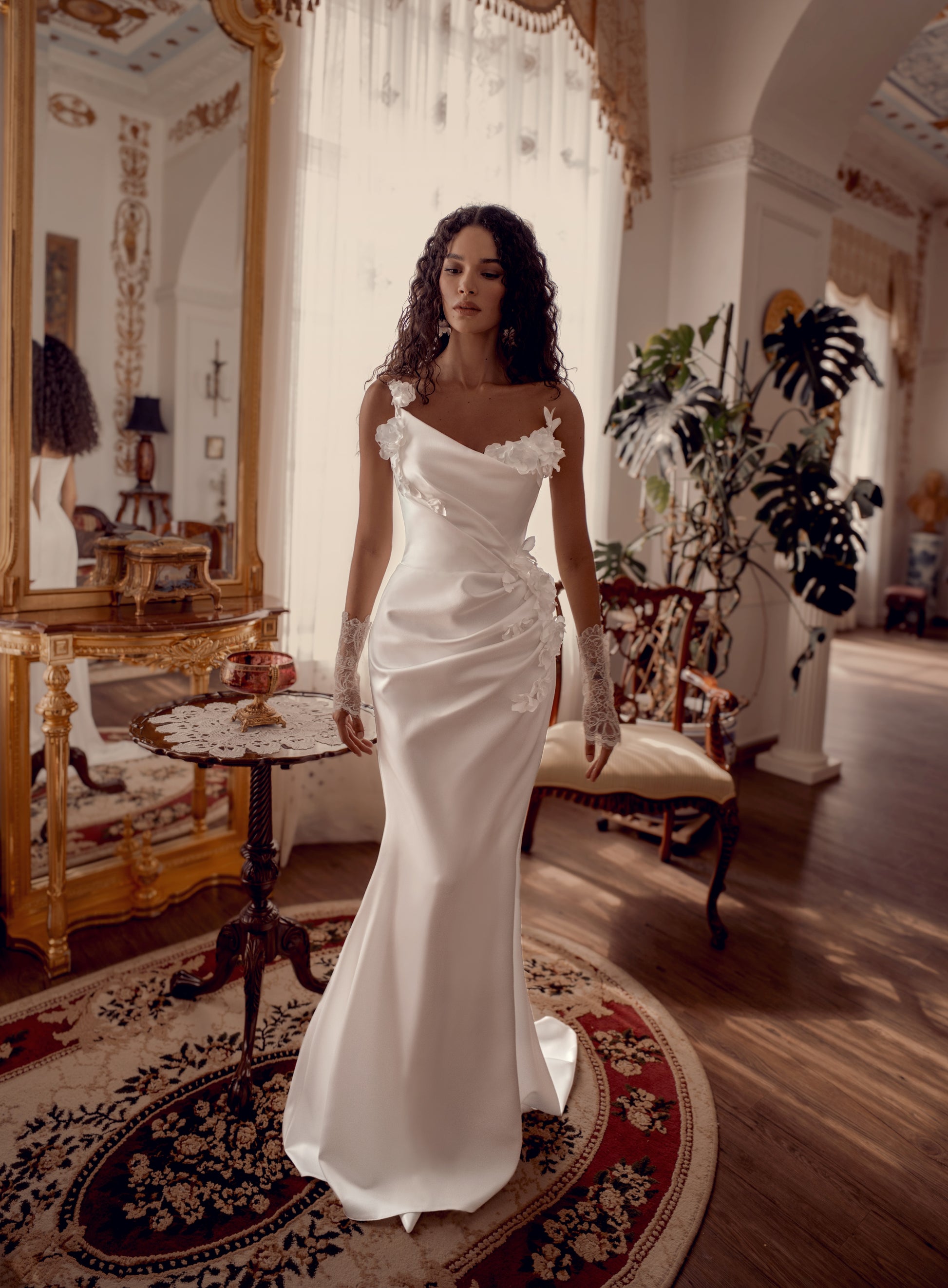 Silk satin wedding gown with asymmetric draped neckline and 3D floral appliqué.