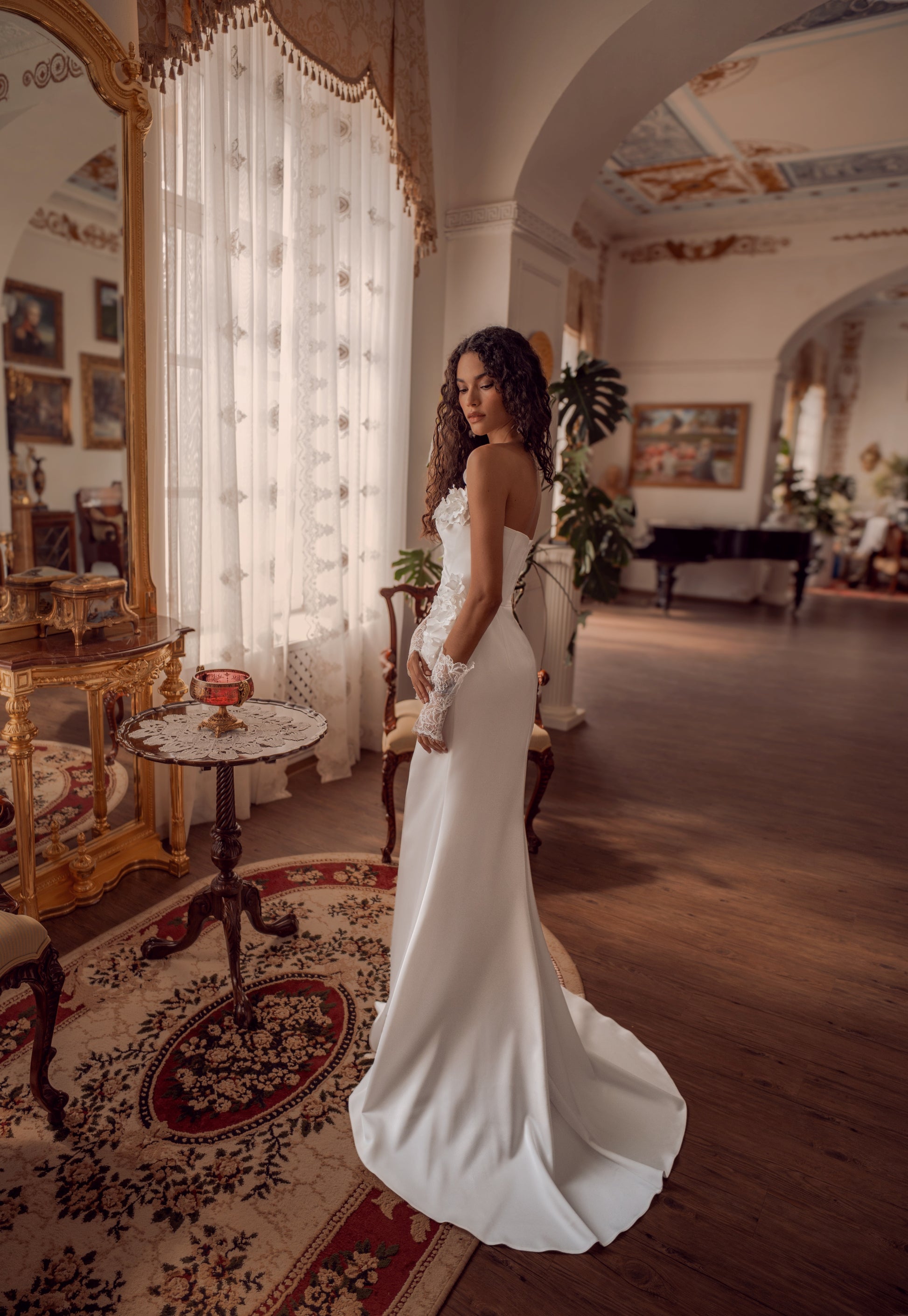 Silk satin wedding gown with asymmetric draped neckline and 3D floral appliqué.