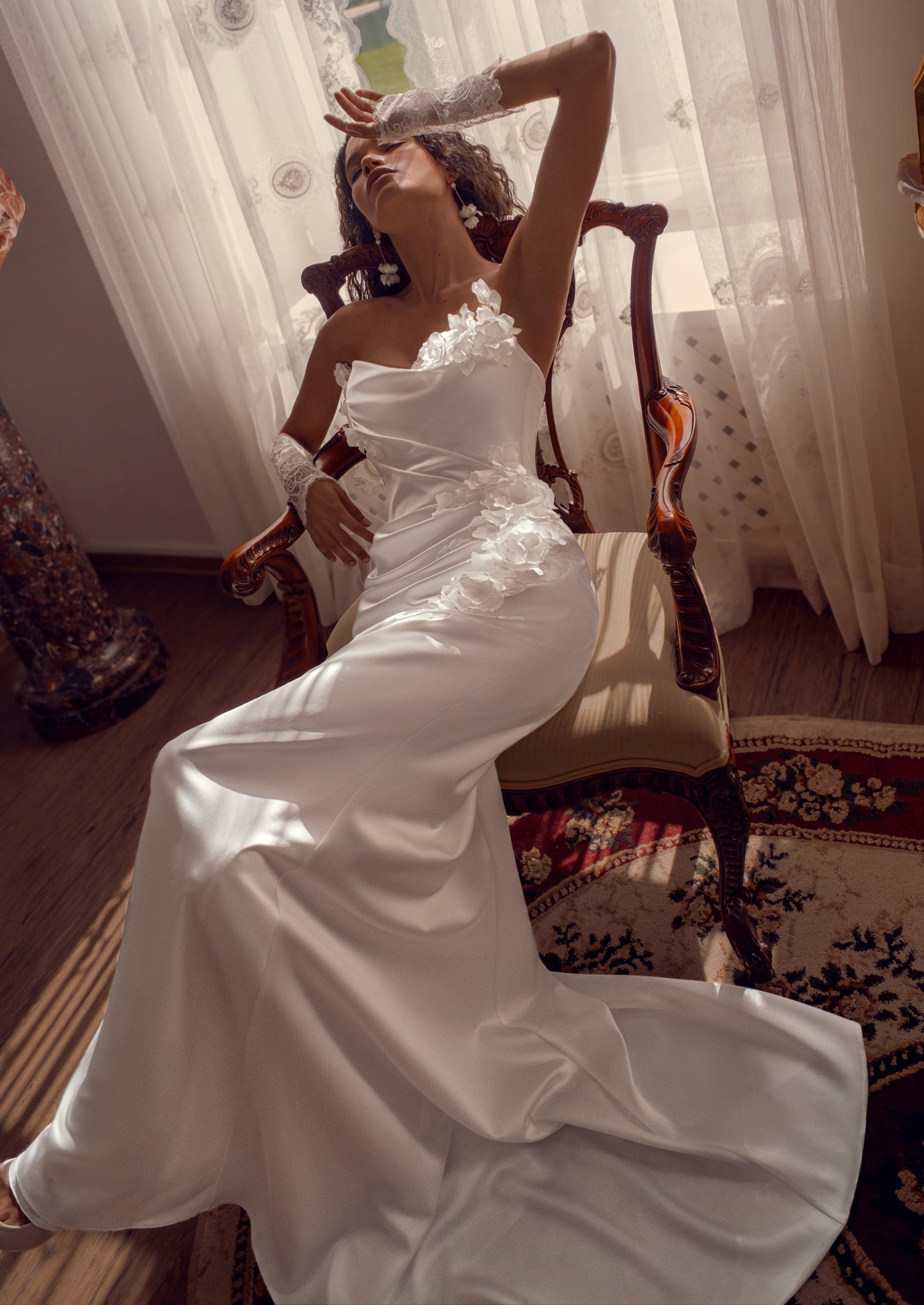 Silk satin wedding gown with asymmetric draped neckline and 3D floral appliqué.