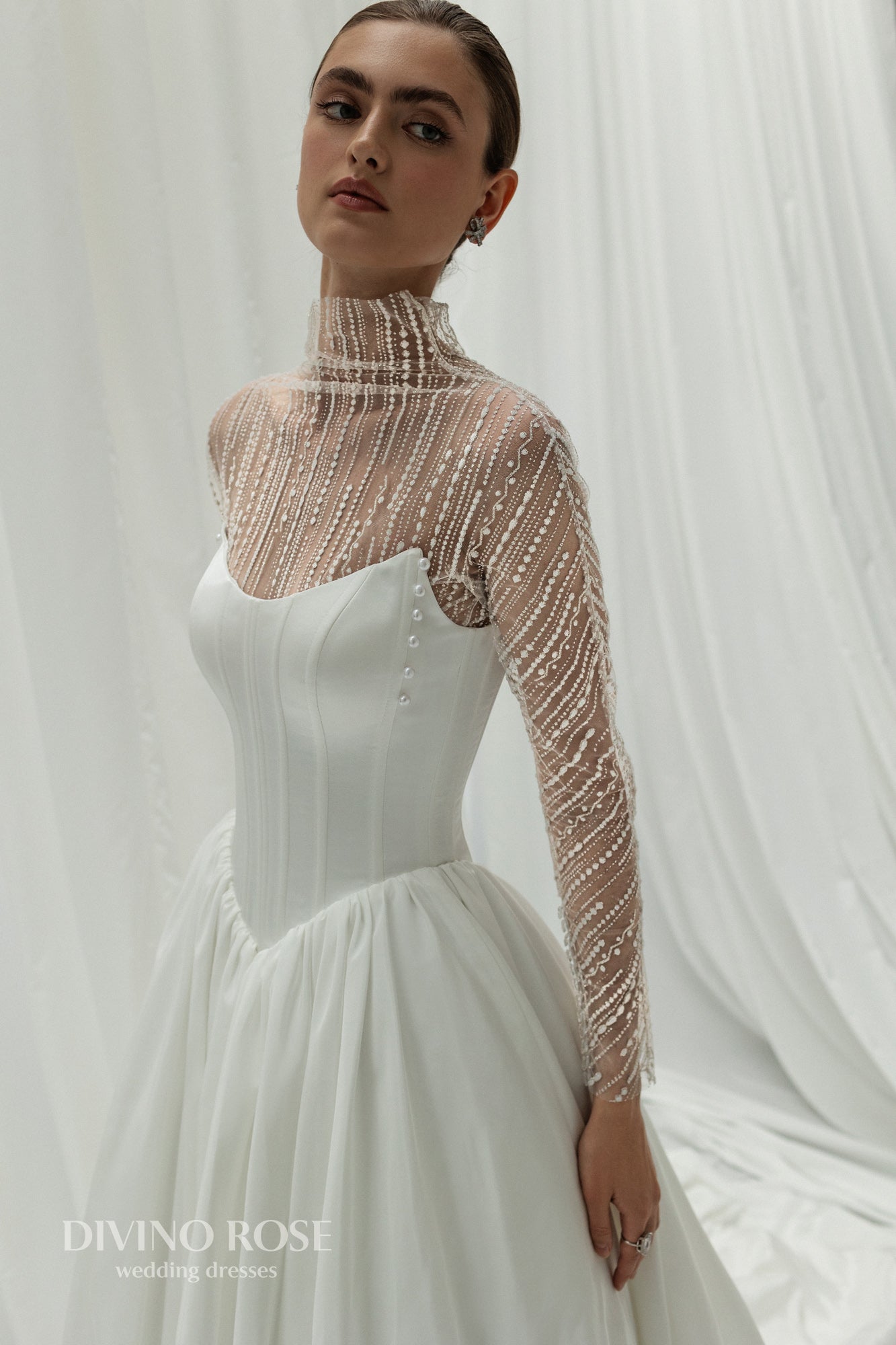 A-line wedding dress with illusion sleeves and corset back.