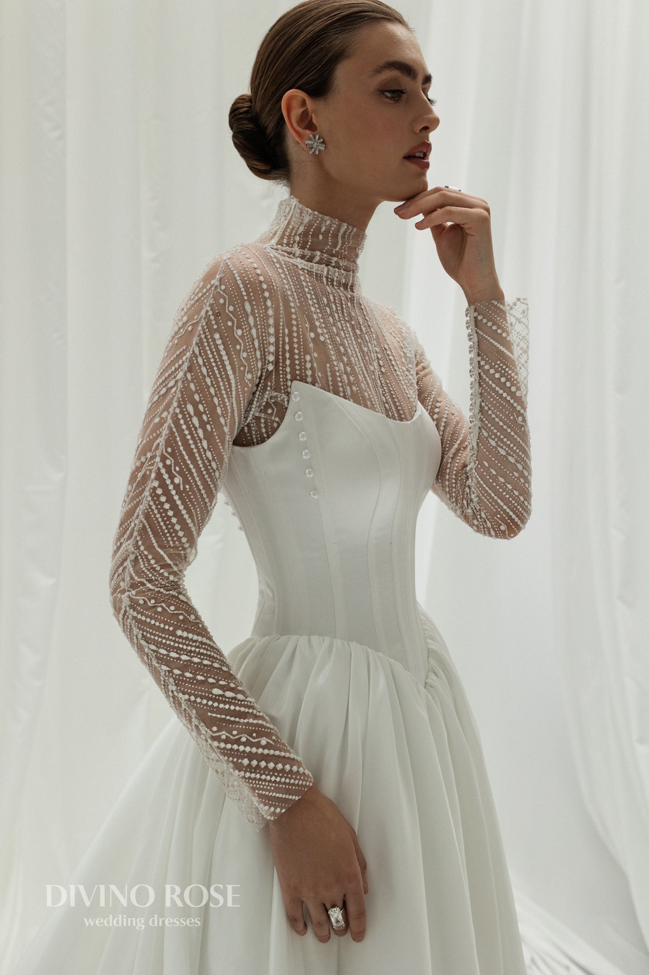 A-line wedding dress with illusion sleeves and corset back.