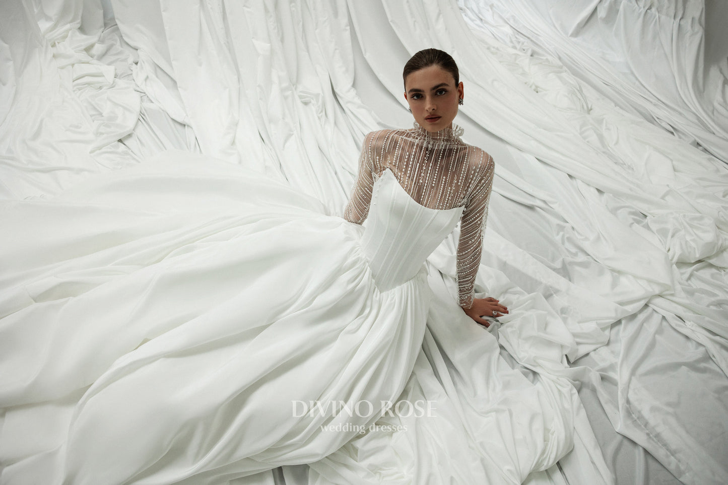 A-line wedding dress with illusion sleeves and corset back.