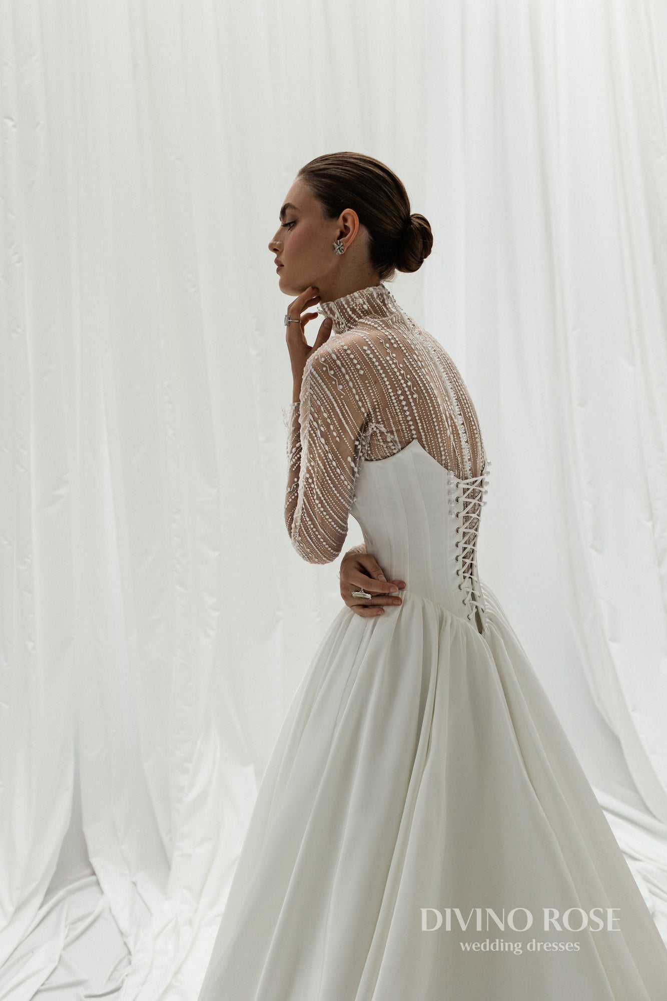 A-line wedding dress with illusion sleeves and corset back.